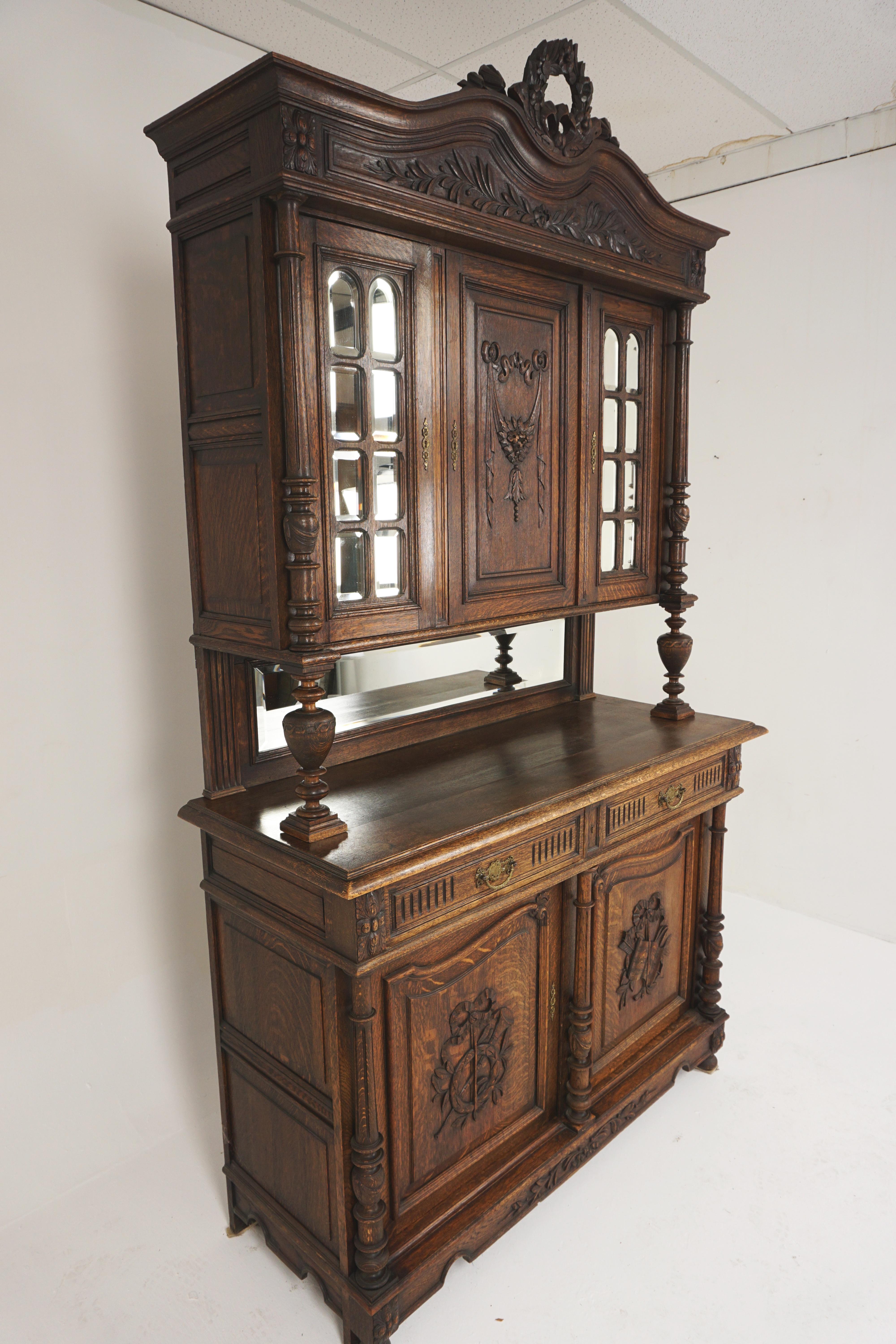Antique buffet hutch, carved oak, France 1890, H044

France 1890
Solid oak
Original finish
Carved cornice on the top with carved flower design to the center
Single carved door flanked by a pair of beveled mirrored doors
Rectangular mirror