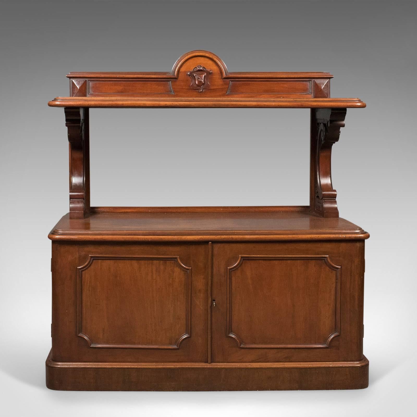 This is an antique buffet, a Scottish server cabinet in mahogany dating to the mid-Victorian period, circa 1870.

Pleasingly patinated and good color throughout
Deep russet tones in the generous stocks of choice mahogany 
Raised on a continuous