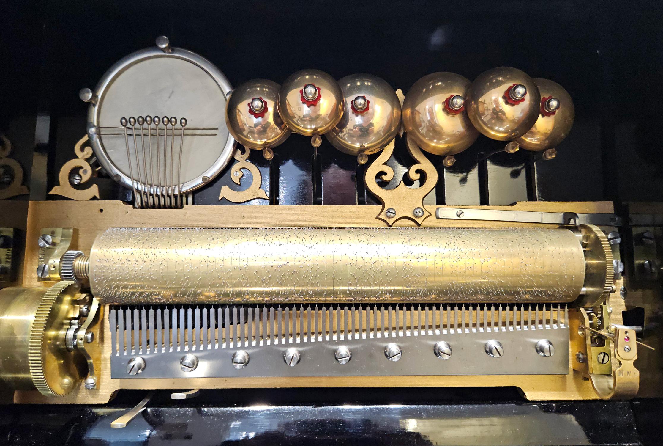 A large and fantastic-sounding buffet-style upright antique music box made by Mojon Manger of Geneva, Switzerland, c. 1885.

The movement features six saucer bells and a skin drum mounted above the cylinder. Both the drum and the bells can be