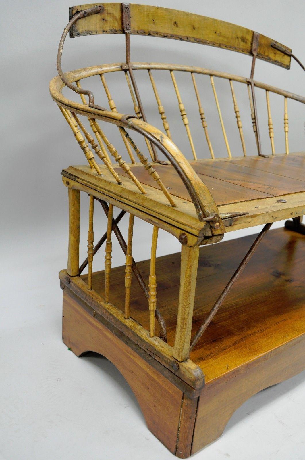 Antique customized buggy bench seat Primitive American Folk Art. Item features original antique buggy bench with spindle-back, solid wood construction, forged iron hardware, quality American craftsmanship, later added pine wood seat and raised base,