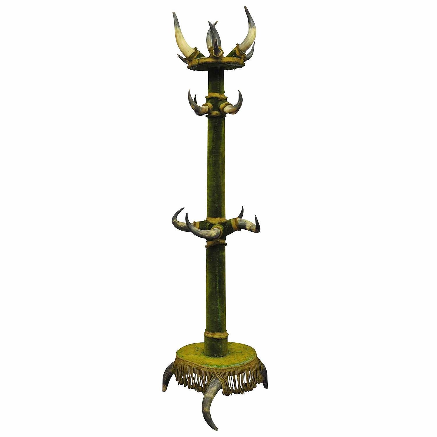 Antique Bull Horn Hall Stand ca .1870

A large bull horn hall stand made of wood, original Austrian cattle horns and a green velvet cover.  Manufactured in Austria ca. 1870. Sturdy condition with original (antique) green velved which has to be