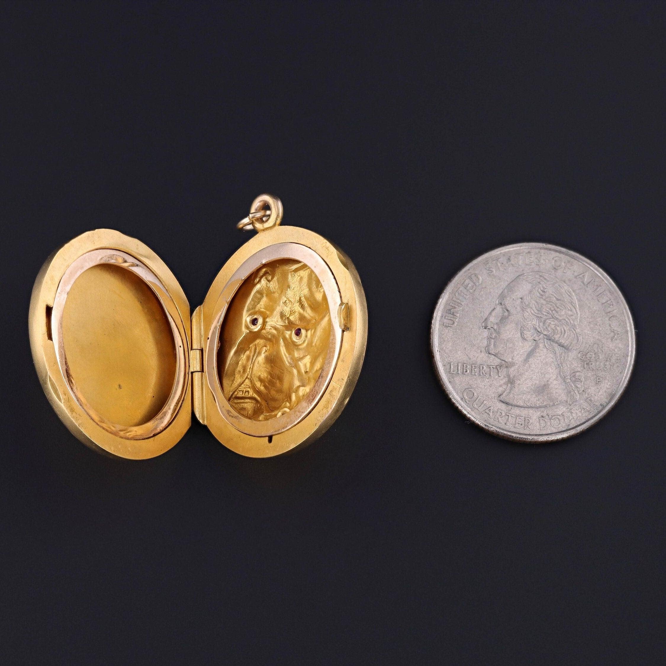 An antique locket -- perfect for anyone with a bulldog or a sentimental attachment to the breed.

This 14k gold locket (circa 1900) depicts a bulldog with ruby eyes and a ruby studded collar. 

The piece measures 1.35 inches from the top of the jump