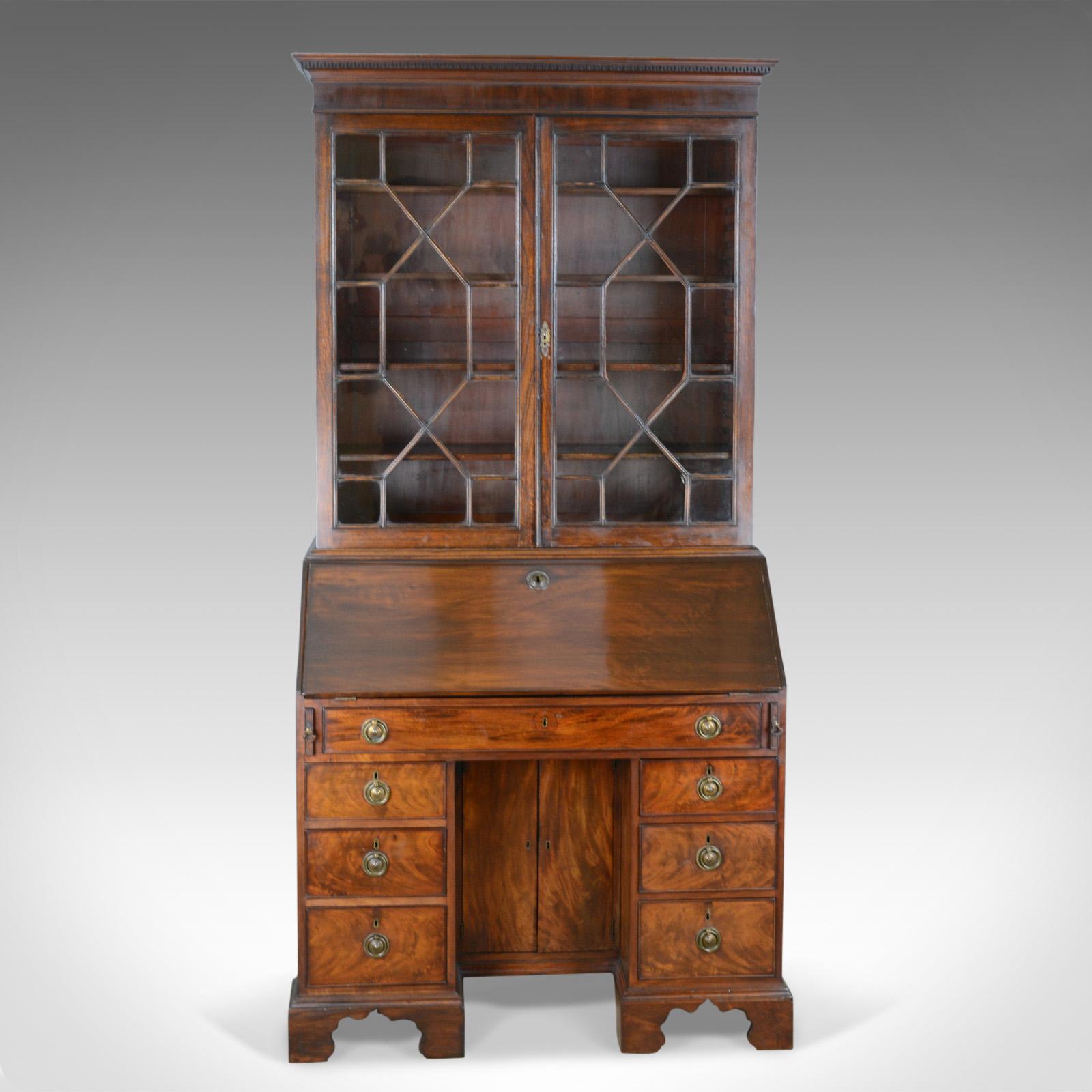 This is an antique bureau bookcase, an English, Georgian, mahogany cabinet dating to the late 18th century, circa 1800.

Classic glazed display cabinet over a practical writing bureau 
Generous in size offering storage and display or bookshelf