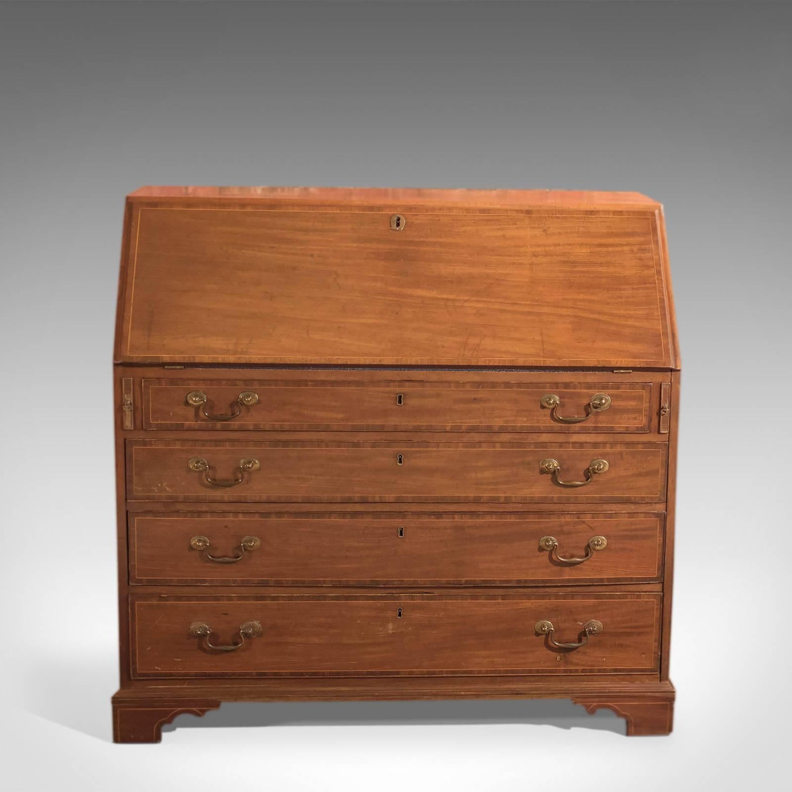 This is an antique bureau dating to the late 18th century, circa 1780.

Raised on shaped bracket feet highlighted with fine string detail and finished in wonderfully grained mahogany, this piece of Classic furniture offers plenty of storage and