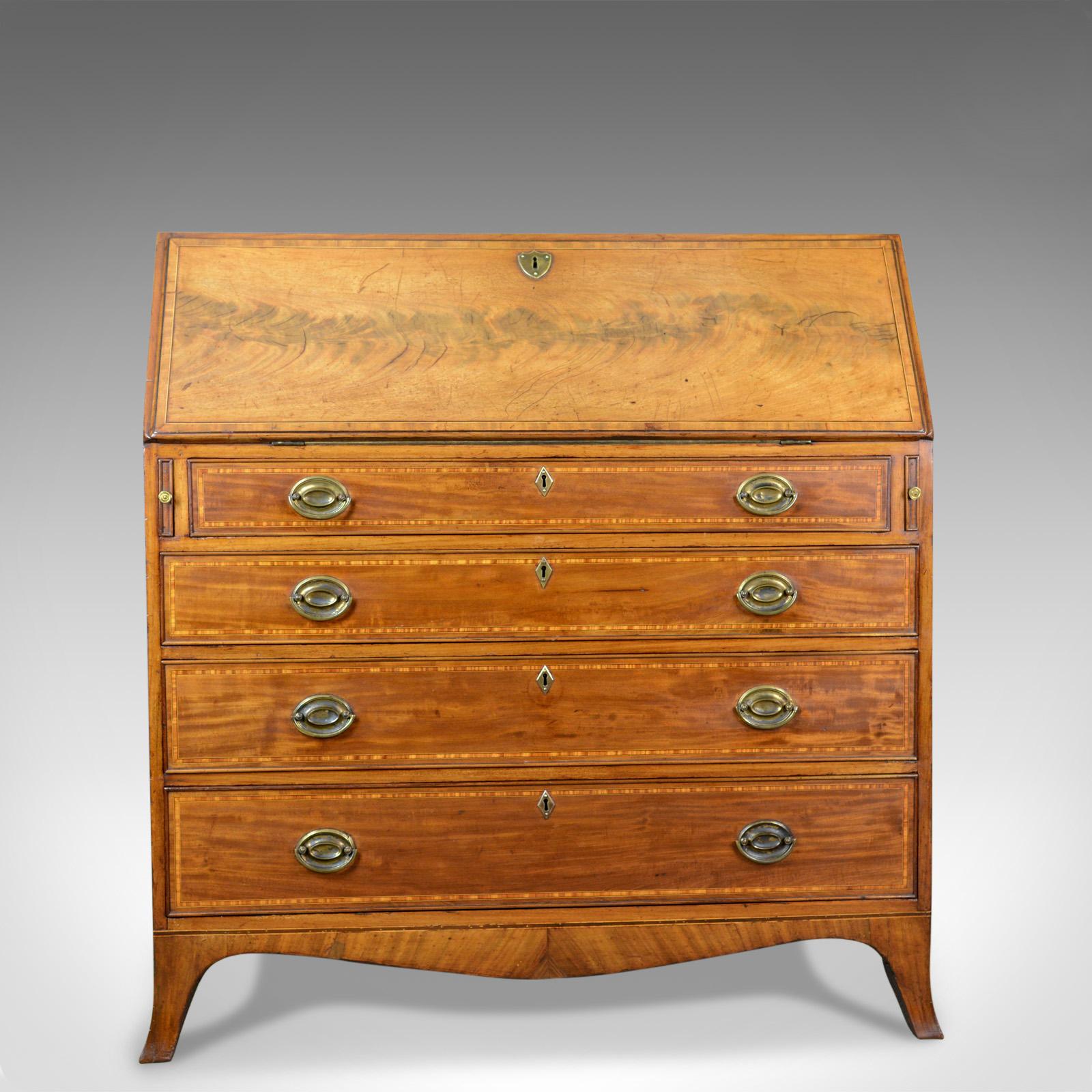 This is an antique bureau in light mahogany. An English, Georgian desk dating to the mid-18th century, circa 1770.

Quality craftsmanship in polished mahogany
Good color and grain interest throughout
Crossband decoration held in tramline ebony