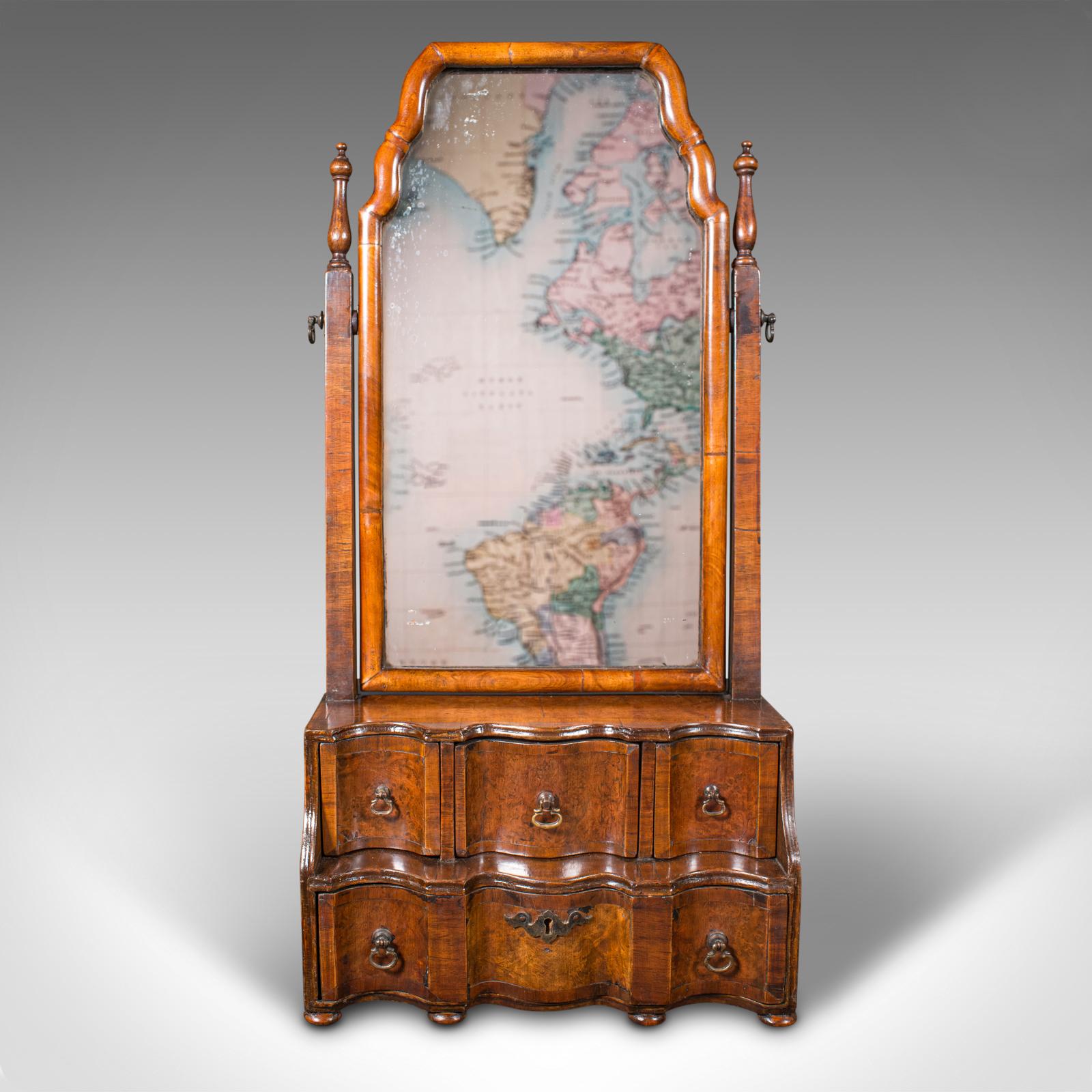 This is an antique bureau mirror. An English, walnut and glass mirror in Queen Anne taste, dating to the Victorian period, circa 1880.

Delightfully presented with fascinating overtones
Displays a desirable aged patina throughout
Select walnut