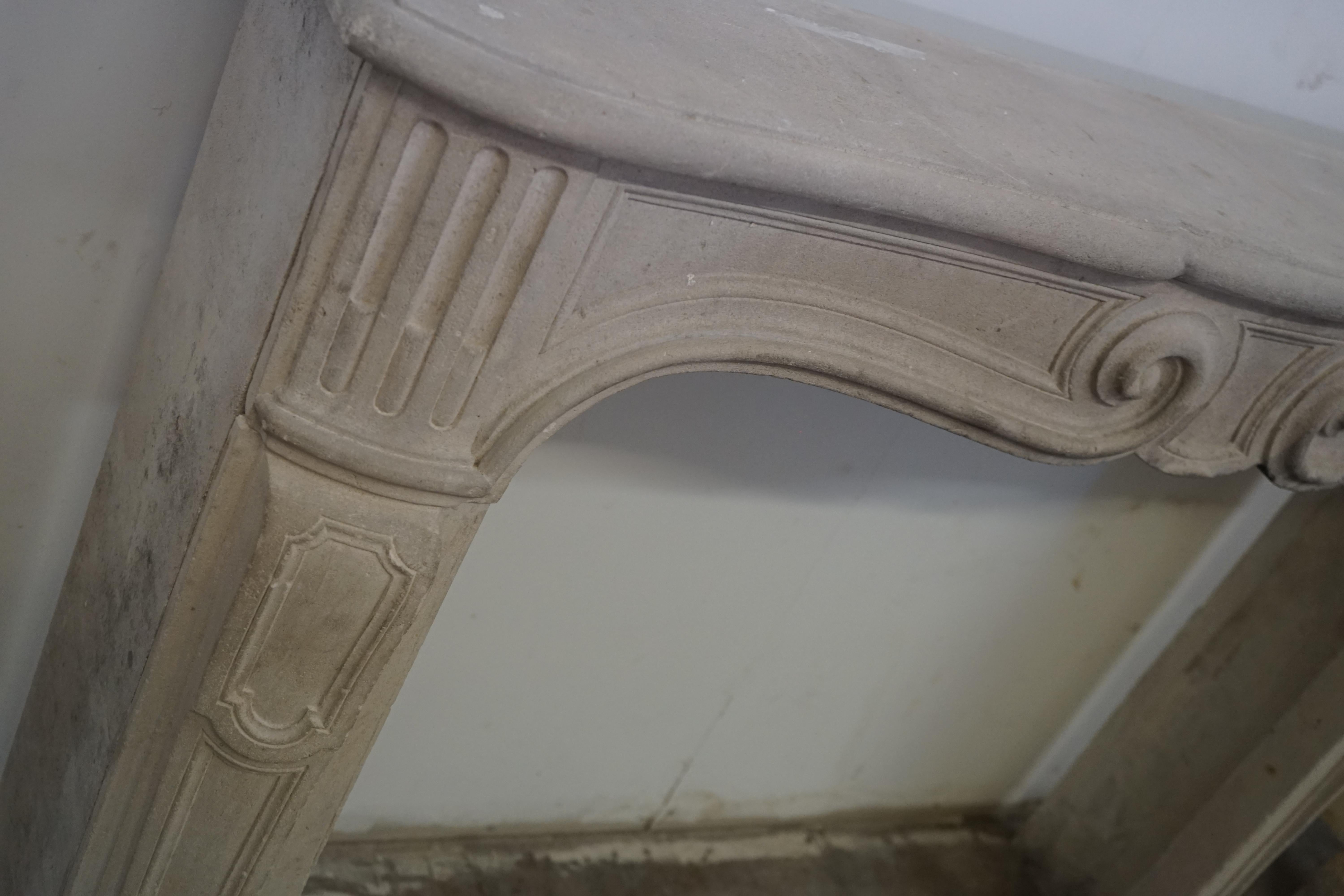 A very beautiful antique Burgundy limestone. The mantel has a decorated shelf with straight legs. It's from the 18th century in the style of King Louis XIV. The mantel has even proportions perfect for a bedroom or breakfast room mantel.