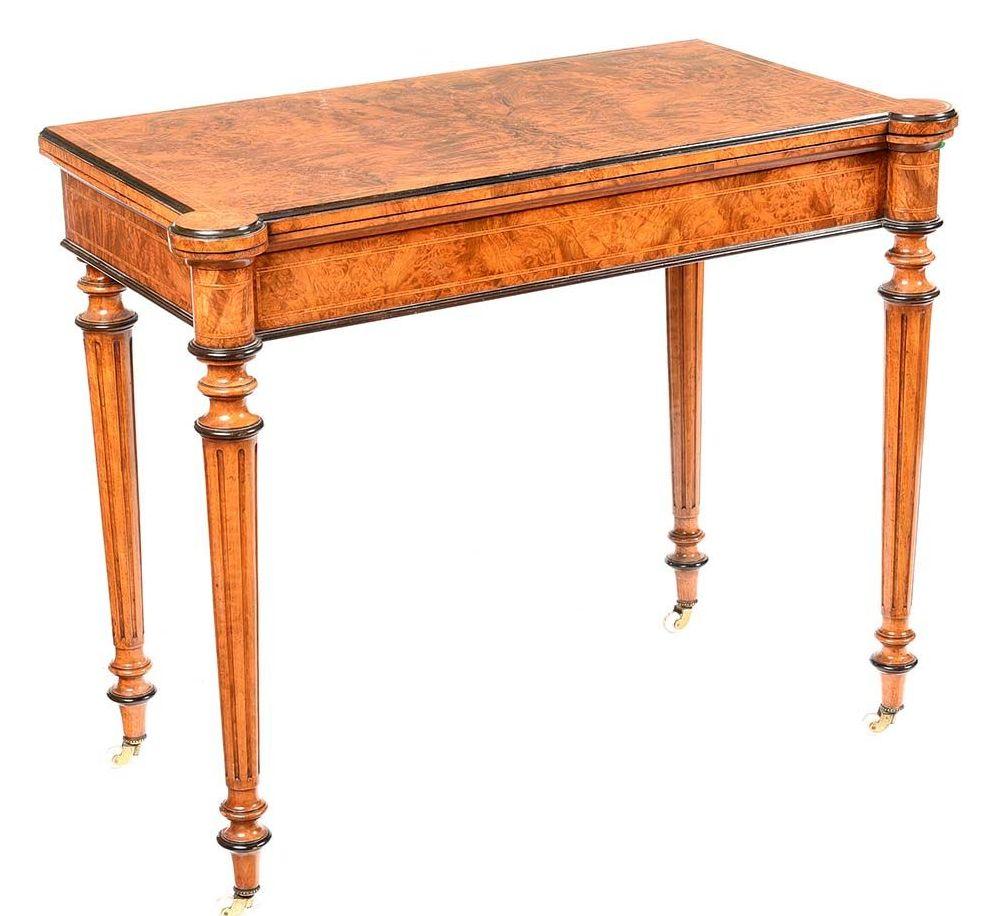 An exceptionally fine quality English early Victorian Period well figured walnut and ebony Fold-over Card Table, firmly attributed to Gillows of Lancaster and London. Third quarter of the Nineteenth Century. 

The hinged fold-over rectangular top