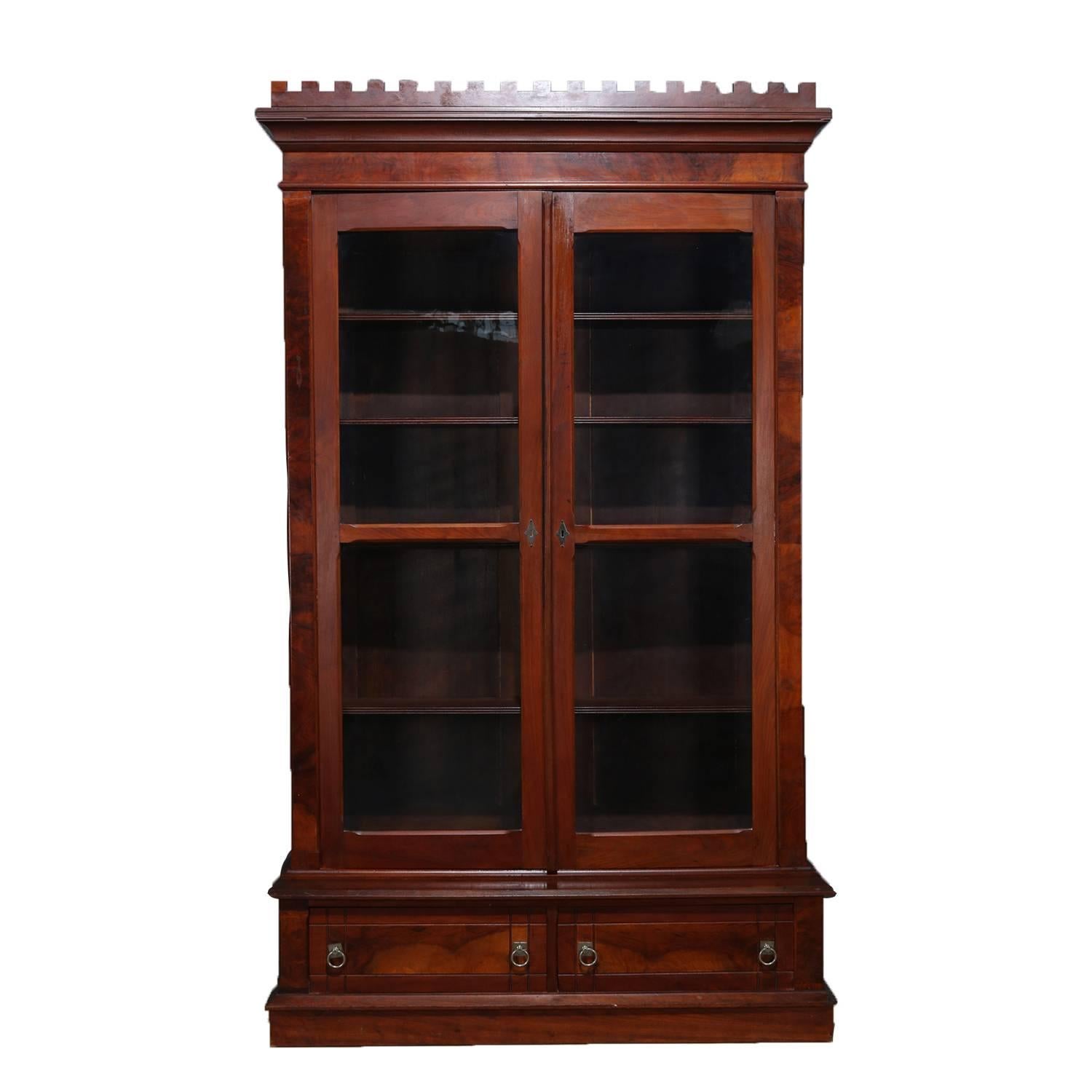 Antique burl walnut bookcase features stepped back upper cabinet with open dental molding crest above two glass doors opening to reveal adjustable shelf interior, lower with two drawers, circa 1840

Measures: 90