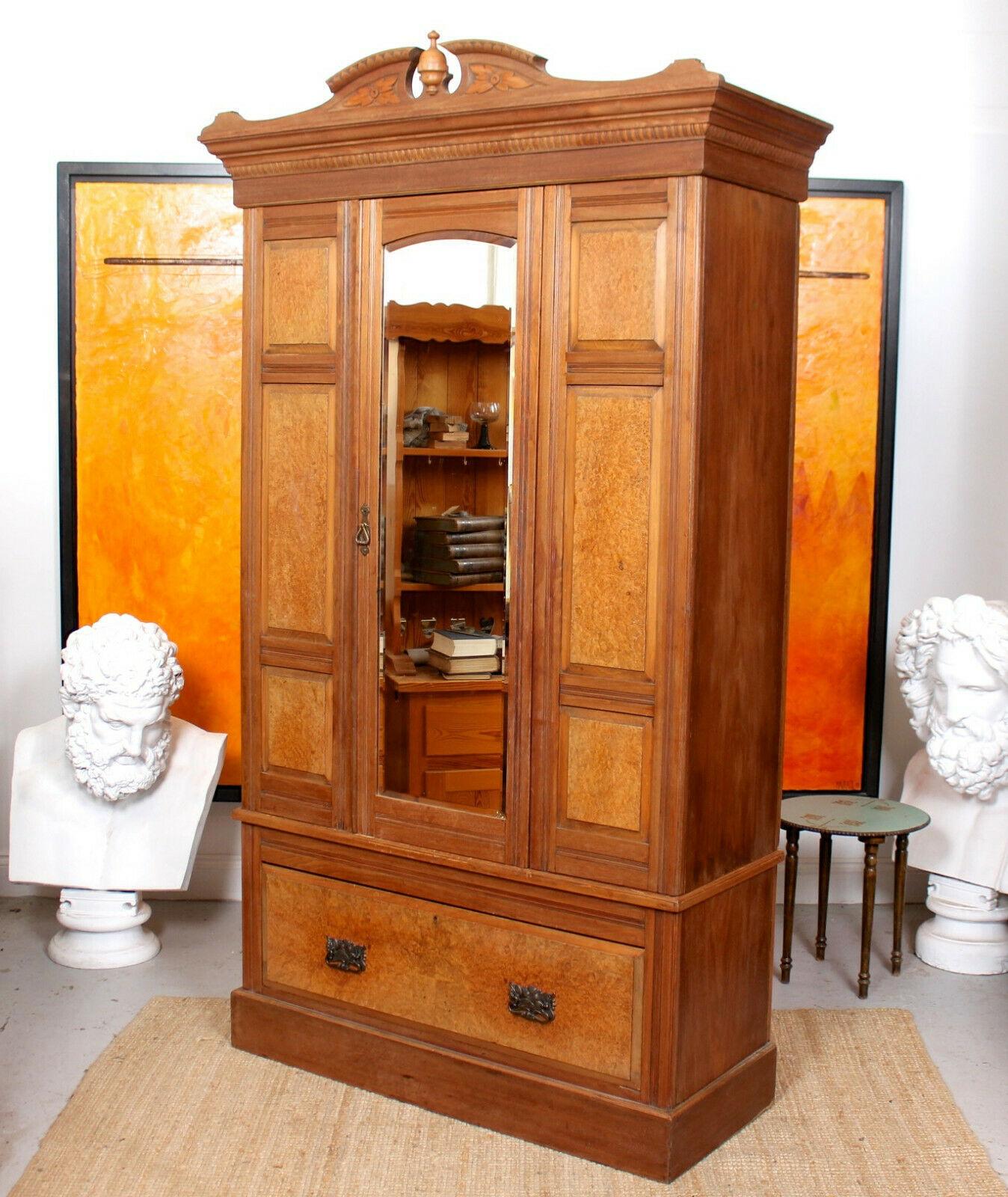 A fine quality 19th century burl walnut wardrobe.

A finely carved cornice above an arched bevelled mirrored door - flanked by burl walnut panels - enclosed hanging rails and hooks to the interior. Fitted a burl walnut drawer to the base mounted