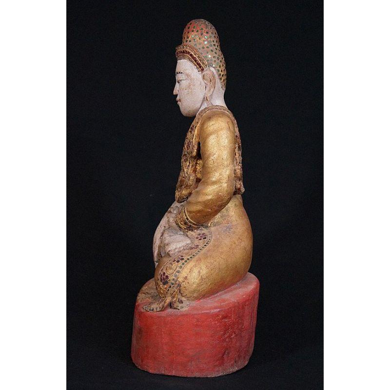 Material: wood
Measures: 49 cm high 
29 cm wide
Weight: 5.35 kgs
Gilded with 24 krt. gold
Mandalay style
Bhumisparsha mudra
Originating from Burma
19th century.

