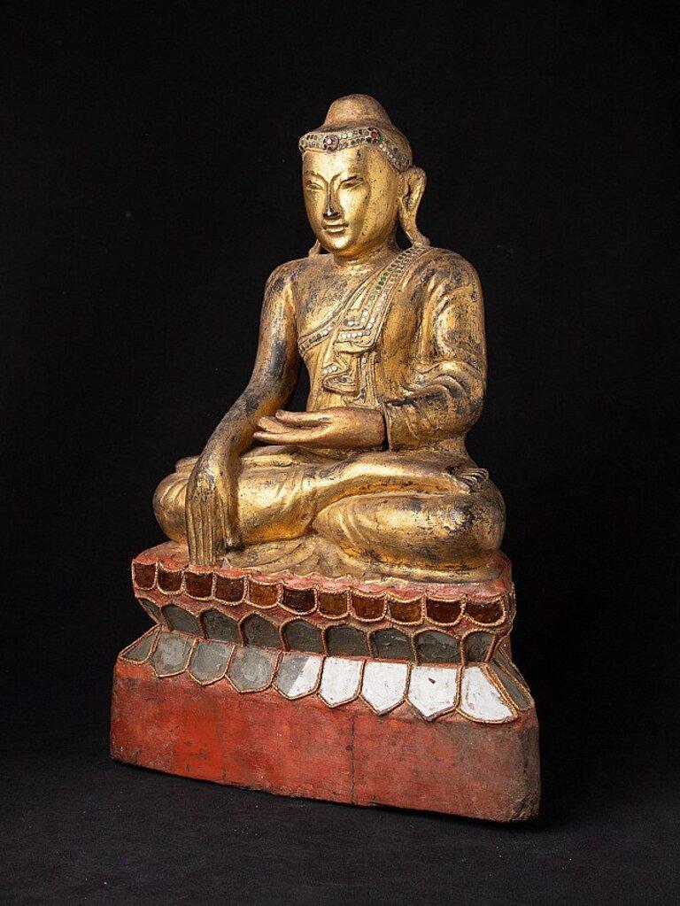 Material: wood
56,8 cm high 
37 cm wide and 16,4 cm deep
Weight: 9.6 kgs
Gilded with 24 krt. gold
Bhumisparsha mudra
Originating from Burma
19th century.
 