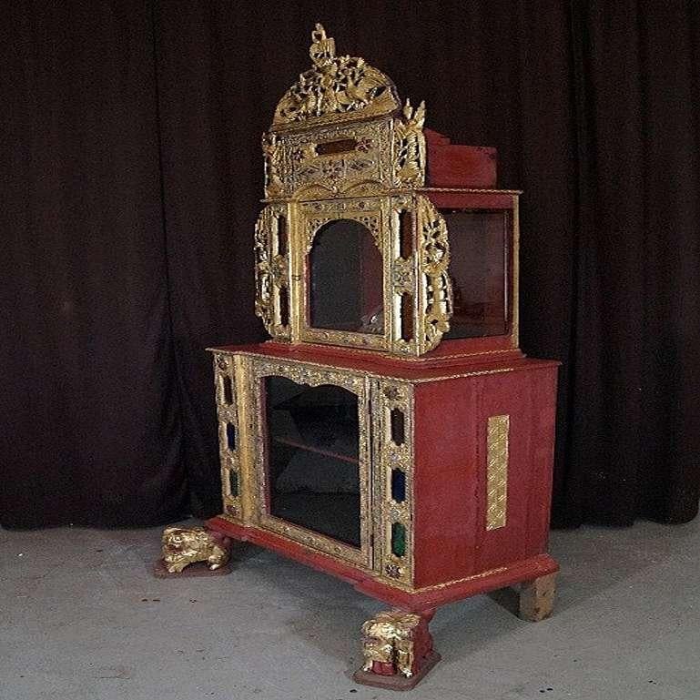 Material: wood
185 cm high 
85 cm wide
50 cm deep
Mandalay style
Originating from Burma
19th century
Gilt with 24 krt. gold leaf
Two parts
The Buddha statue inside is not included

 