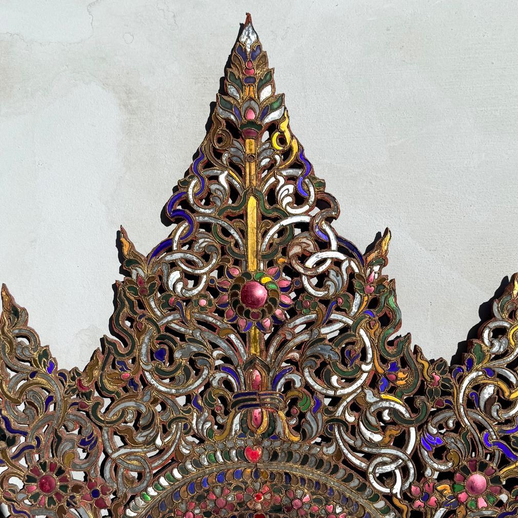 Antique Burmese Buddhist Decorative Backboard Mandorla  Panel. A style of surround for a seated Buddha image reminiscent of a Burmese transom in shape. The peaked triangular panel intricately carved with flamiform peaks. The overall body carved in