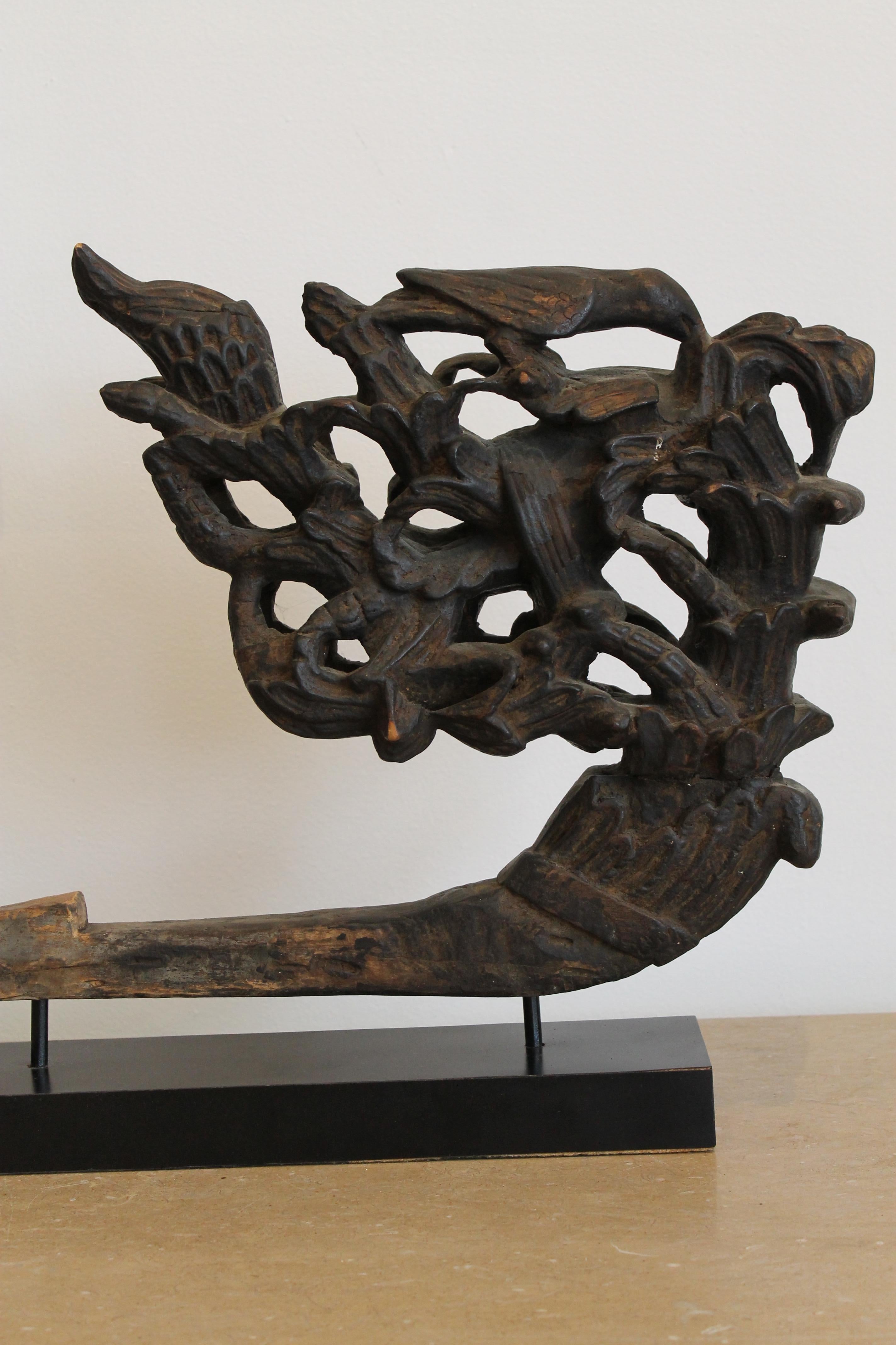 A late 18th to early 19th century Burmese carved wood ox wagon pointer. Great vintage condition, with heavy patina, mounted to a black laminated wood display base. Carving measures 21