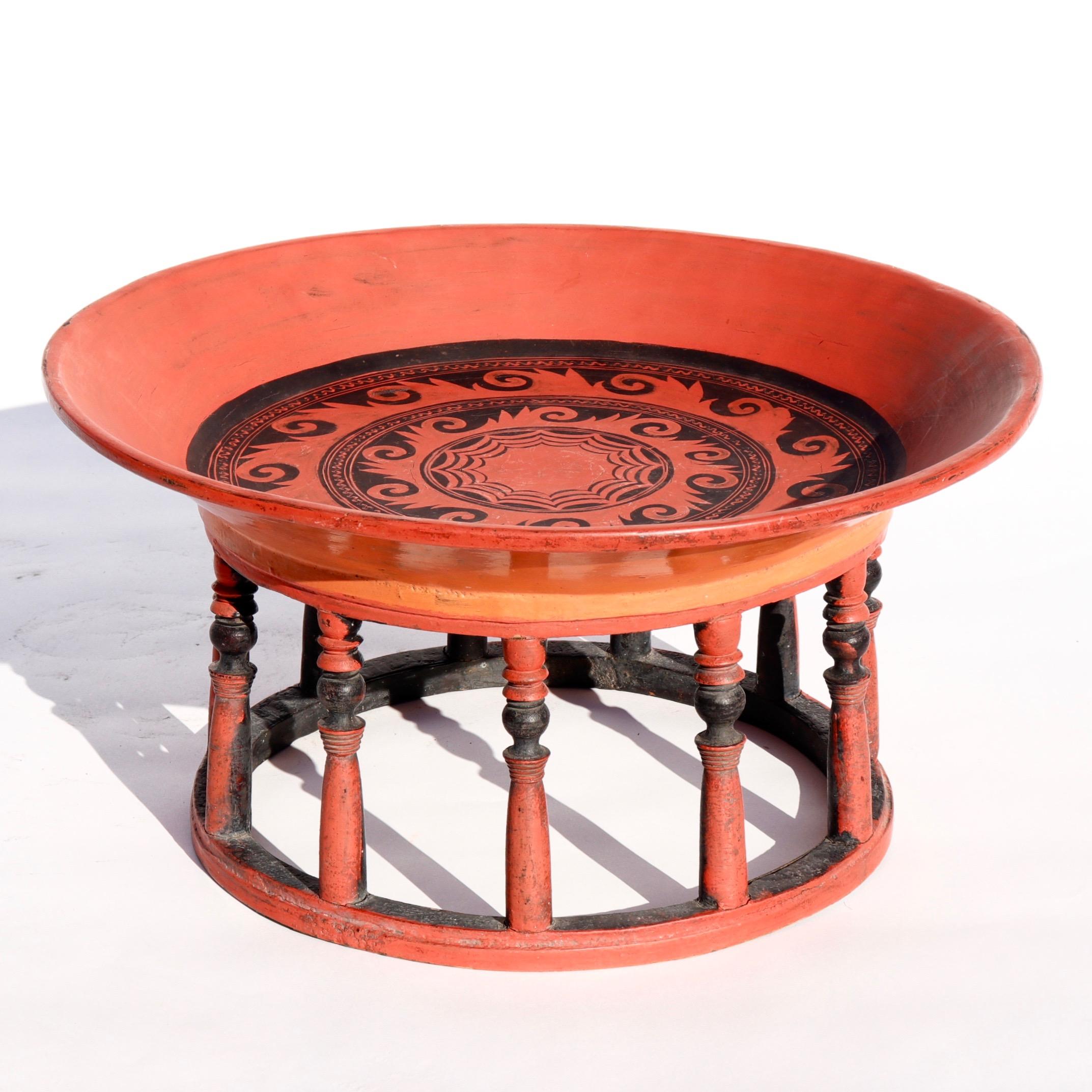 Antique Burmese kalat lacquered offering tray, Shan States, Inle Lake, circa 1920. Assembled from wood and rattan covered in red, orange and black lacquer. A simple circular form with 11 turned spindle uprights and broad rimed woven tray with