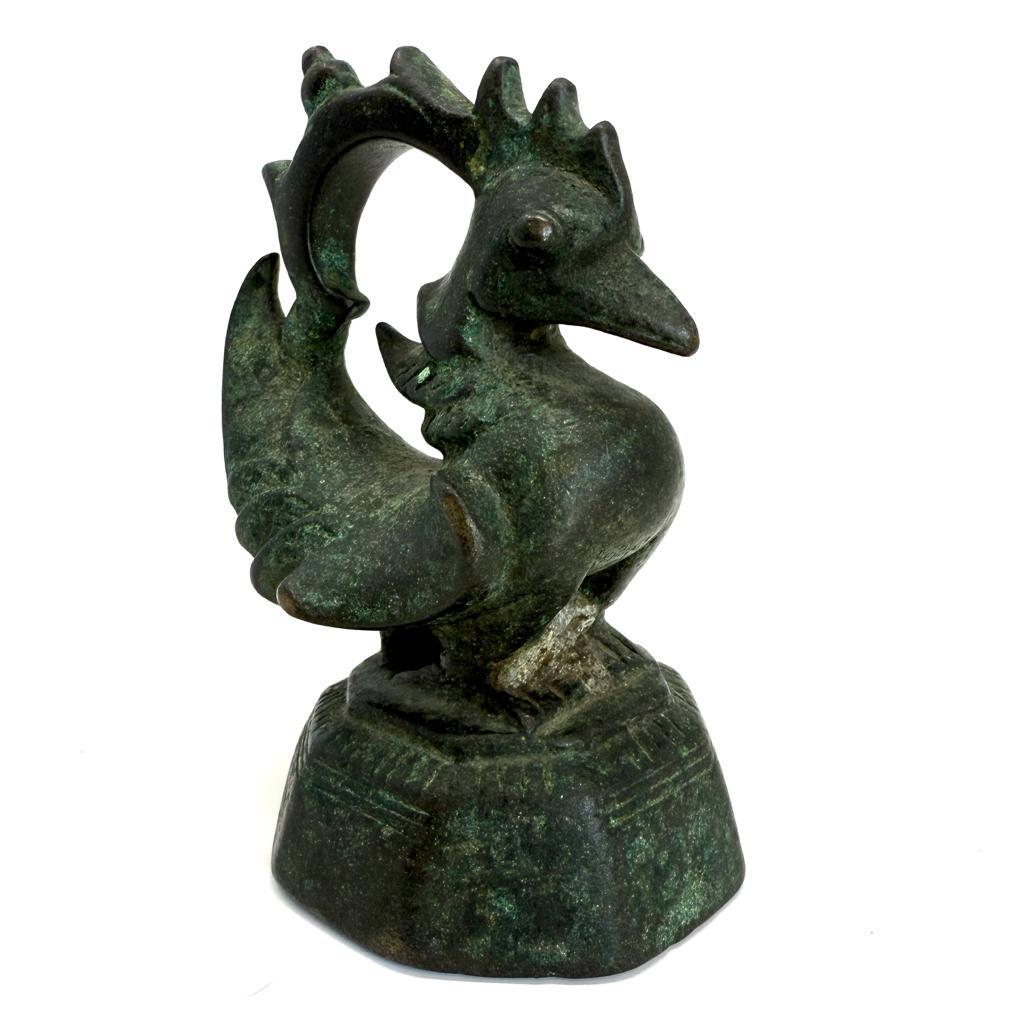Antique Burmese 1 viss A-le, a zoomorphic form bronze market weight often referred to as an “opium weight”, in the form  of a Karaweik, a Burmese crane with pointed  beak, bulging eyes, side wings and upturned tail standing on a tapered octagonal