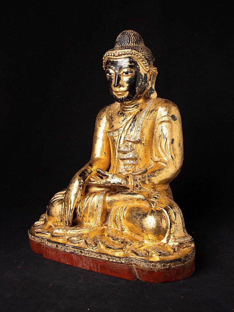 Material: wood
41,3 cm high 
32,9 cm wide and 23 cm deep
Weight: 4.85 kgs
Gilded with 24 krt. gold
Mandalay style
Bhumisparsha mudra
Originating from Burma
19th century
Mit eingelegte Augen
