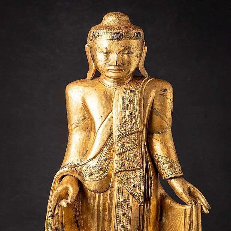 Material: wood
97,3 cm high 
32,7 cm wide and 24 cm deep
Weight: 7.3 kgs
Gilded with 24 krt. gold
Mandalay style
Originating from Burma
19th century
With inlayed eyes.
 