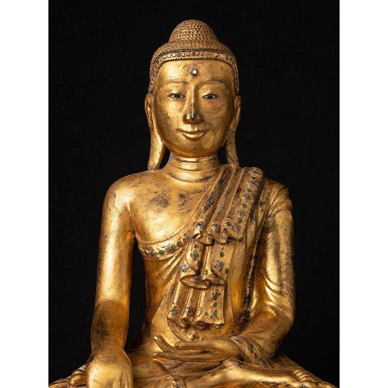 Material: lacquerware
Measures: 62 cm high 
36,8 cm wide and 28,5 cm deep
Weight: 3.45 kgs
Gilded with 24 krt. gold
Mandalay style
Bhumisparsha mudra
Originating from Burma
Early 19th century
With inlayed eyes

