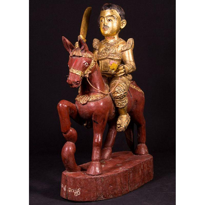 Material: wood
57 cm high 
16 cm wide and 38 cm deep
Weight: 6.05 kgs
Gilded with 24 krt. gold
Originating from Burma
19th century
With inlayed eyes
With Burmese inscriptions in the base

 