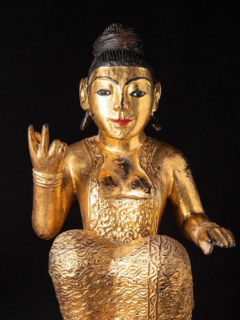 Material: wood
56 cm high 
27 cm wide and 25 cm deep
Weight: 8.15 kgs
Gilded with 24 krt. gold
Originating from Burma
19th century.
 