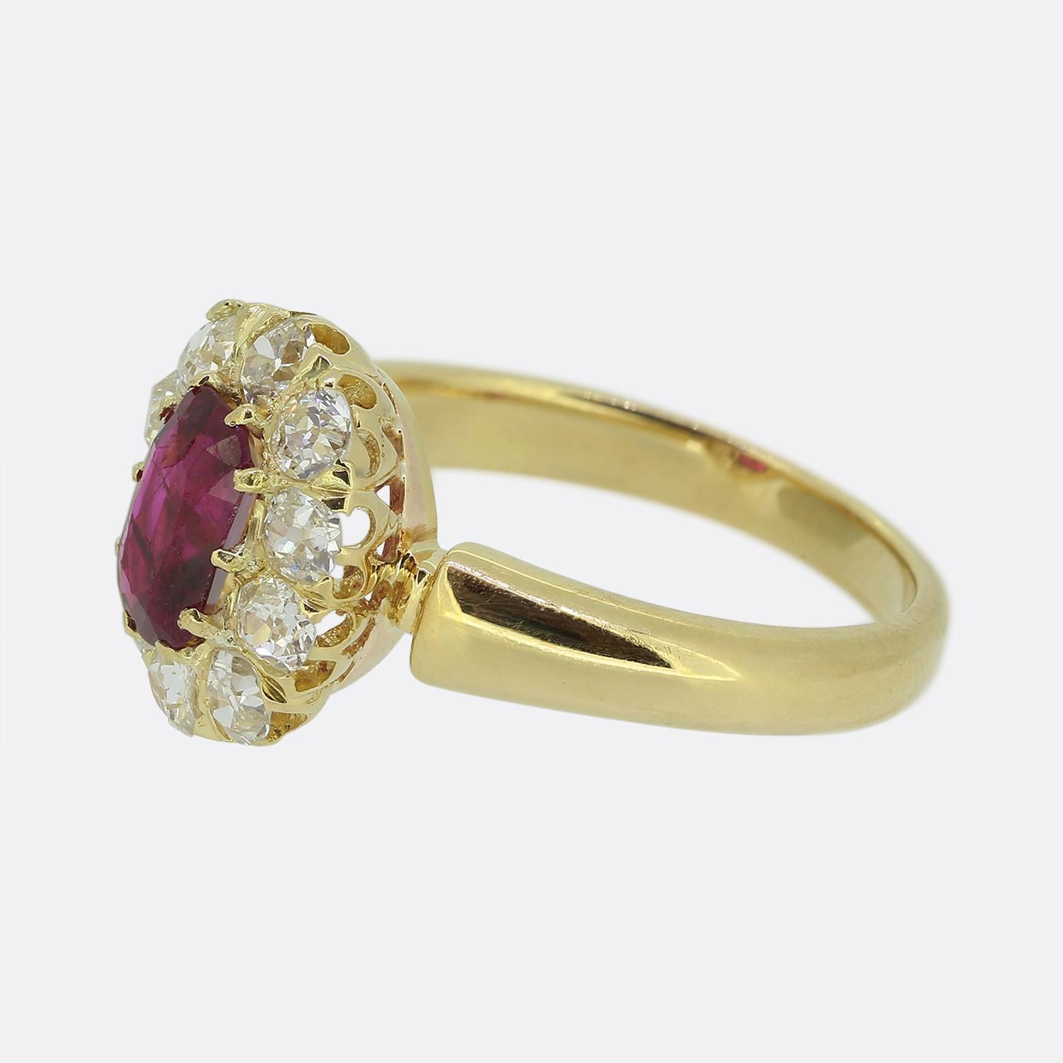 Here we have a truly beautiful ruby and diamond cluster ring. At the centre of the face we find an oval shaped natural Burmese ruby possessing a mid red colour tone with no evidence of heat treatment. The centre stone is then surrounded by a single