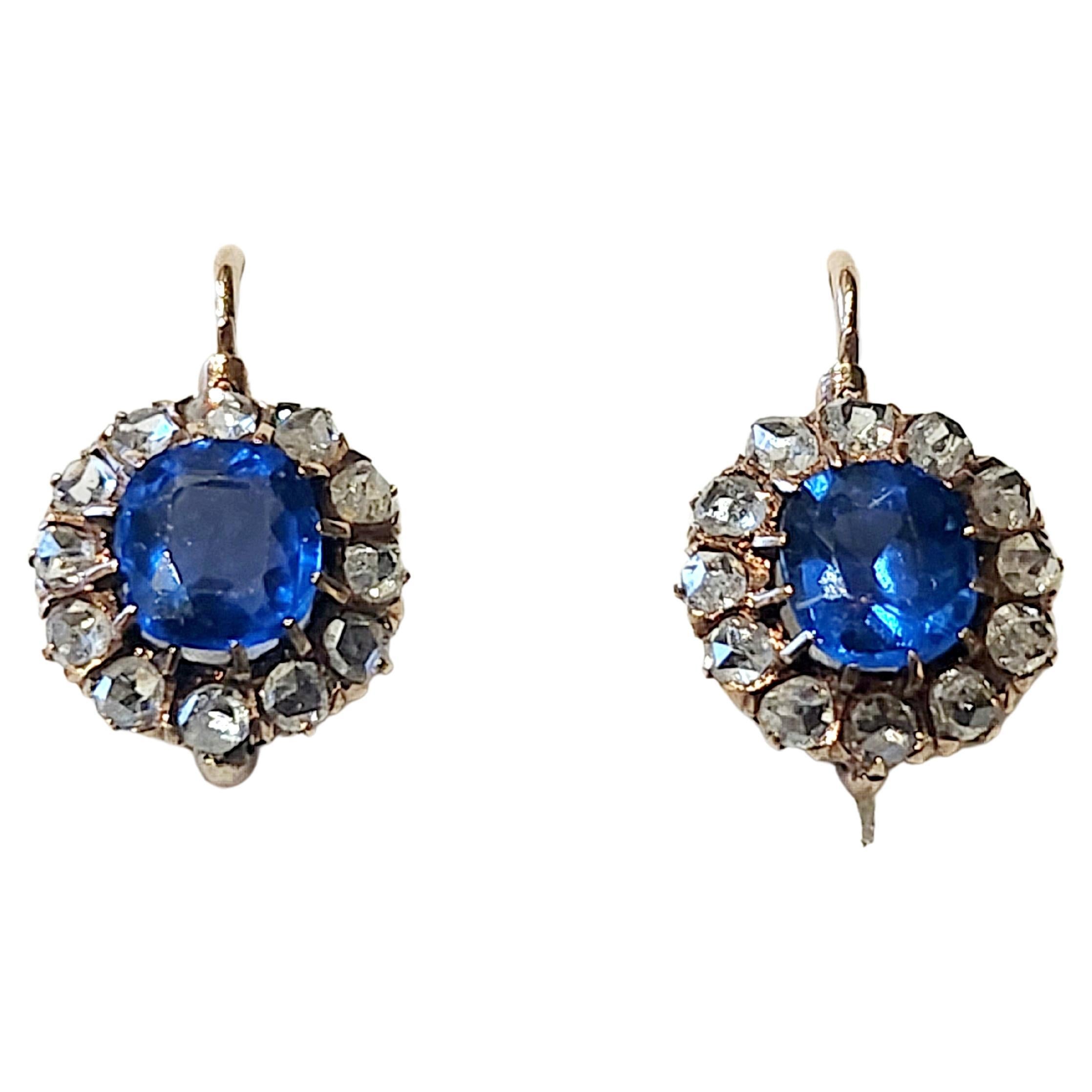 Antique 1880.c earrings centered with natural blue burmese sapphire excellent royal blue color flanked with rose cut diamonds in solitare style gold earrings head diameter 5mm estimate sapphire weight 2 carats earrings lenght 1.80cm dates back to