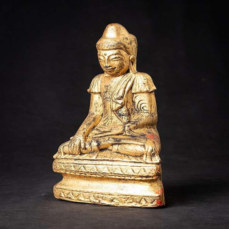 Material: lacquerware
25,8 cm high 
13,9 cm wide and 7,3 cm deep
Weight: 0.635 kgs
Gilded with 24 krt. gold
Shan (Tai Yai) style
Bhumisparsha mudra
Originating from Burma
19th century
Made of lacquerware, on a wooden core.
 