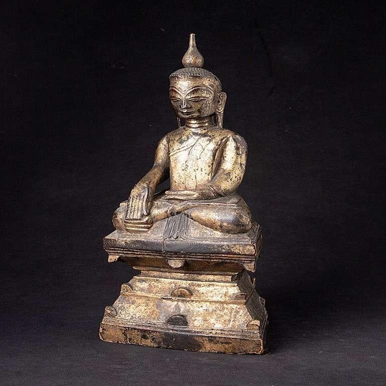 Material: wood
41 cm high 
17,3 cm wide and 10,5 cm deep
Weight: 1.468 kgs
Gilded with 24 krt. gold
Shan (Tai Yai) style
Bhumisparsha mudra
Originating from Burma
Late 18th century
With hollow (probably never opened) space in the backside