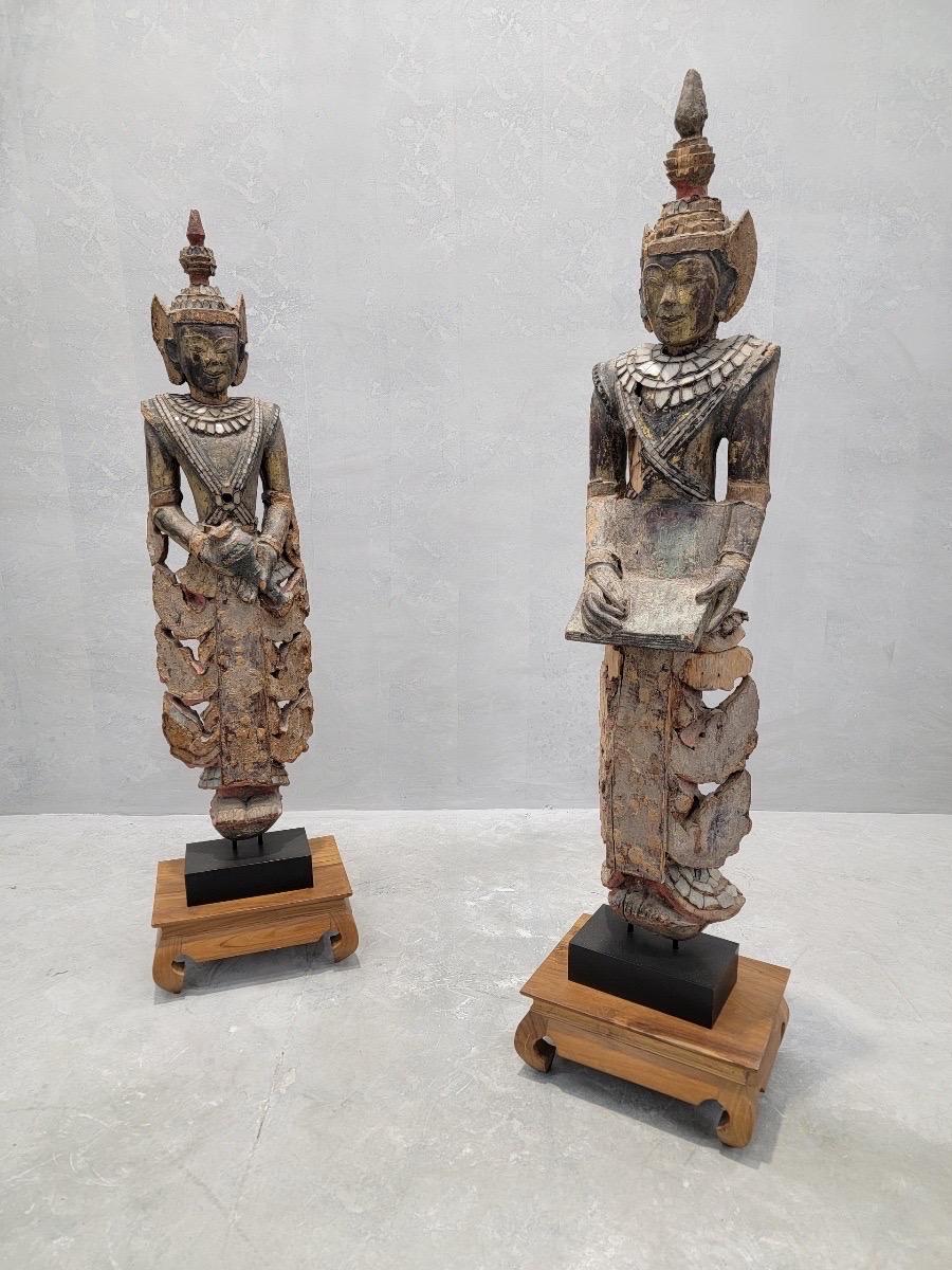 Antique Burmese Carved and Lacquered Wood with Inlaid Colored Glass Short Monastic Attendant Sculptures - Set of 2 

Enhance your home decor with this exquisite set of antique Burmese carved and lacquered wood sculptures, featuring intricate details