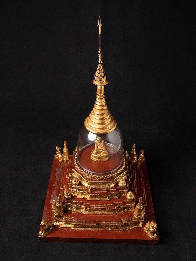 Material: wood
88,5 cm high 
48,5 cm wide and 48,5 cm deep
Weight: 9.65 kgs
Gilded with 24 krt. gold
Originating from Burma
19th century
Including the Buddha statue
There is a very small crack in the glass, but nothing to worry