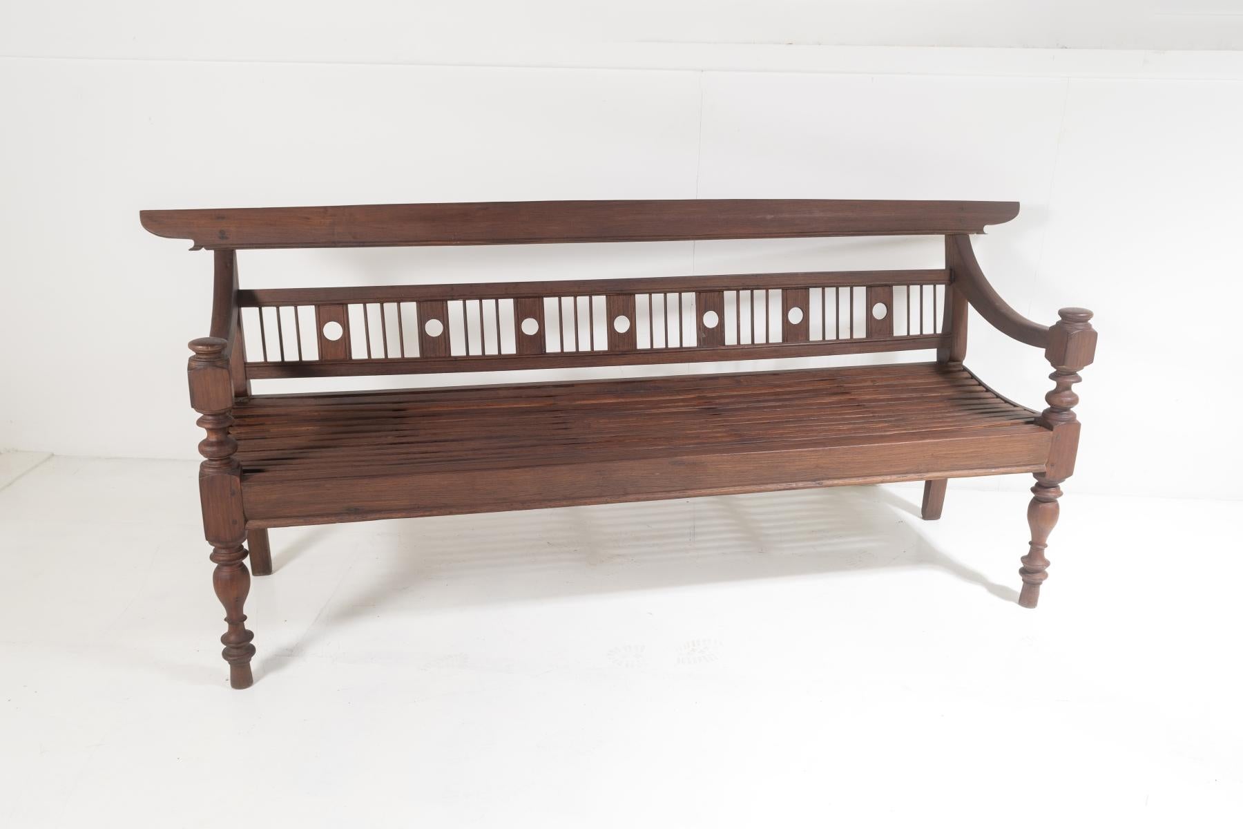 A genuine late 19th century Burmese teak bench from Myanmar (Burma).  A quality piece of craftmanship, with pegged joints and hand crafted throughout, an authentic piece of Myanmar furniture and a rare find in this condition.
A large 3-seater bench