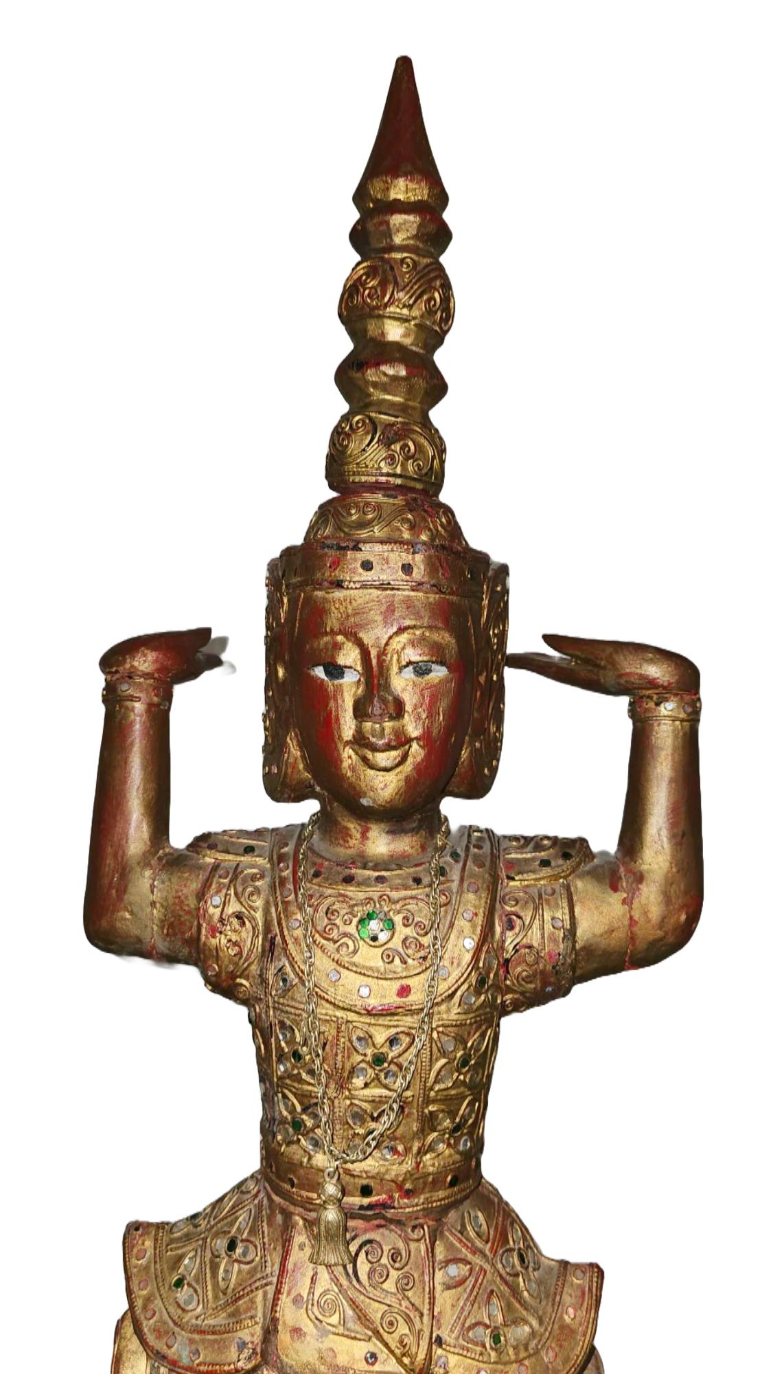 Elevate your collection with this exceptional large antique wood carving, hailing from the rich artistic traditions of Burma or Thailand. This remarkable sculpture features a standing nat figure, meticulously carved and presented with hands in a