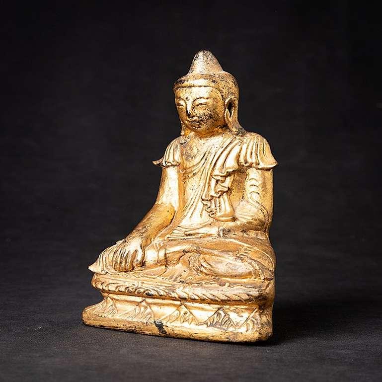 Material: wood
21,5 cm high 
12 cm wide and 6,5 cm deep
Weight: 0.314 kgs
Thickly lacquered and gilded with 24 krt. gold
Shan (Tai Yai) style
Bhumisparsha mudra
Originating from Burma
19th Century.
 