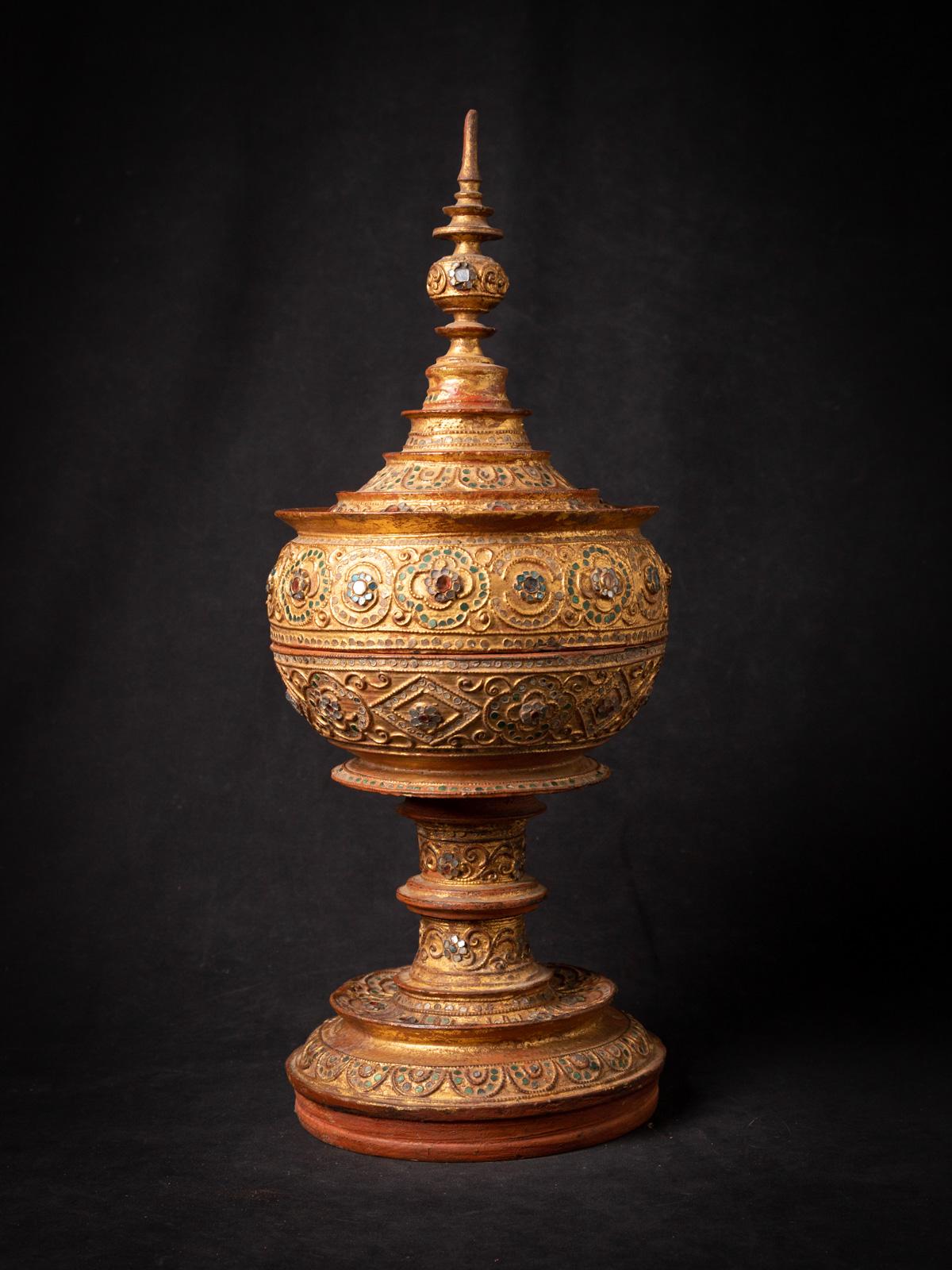 Immerse yourself in the captivating beauty and rich cultural heritage of this remarkable antique Burmese wooden offering vessel.

Crafted with utmost skill and artistry, this vessel stands tall at an impressive height of 52.5 cm, commanding