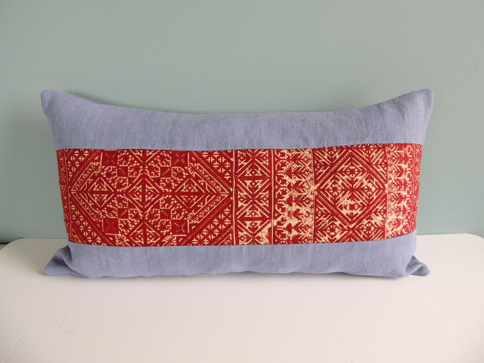 Antique burnt orange embroidered fez decorative long bolster pillow with blue linen frame
and same backing.
Decorative pillow handcrafted and designed in the USA. 
Closure by stitch (no zipper closure) with custom-made feather/ down pillow