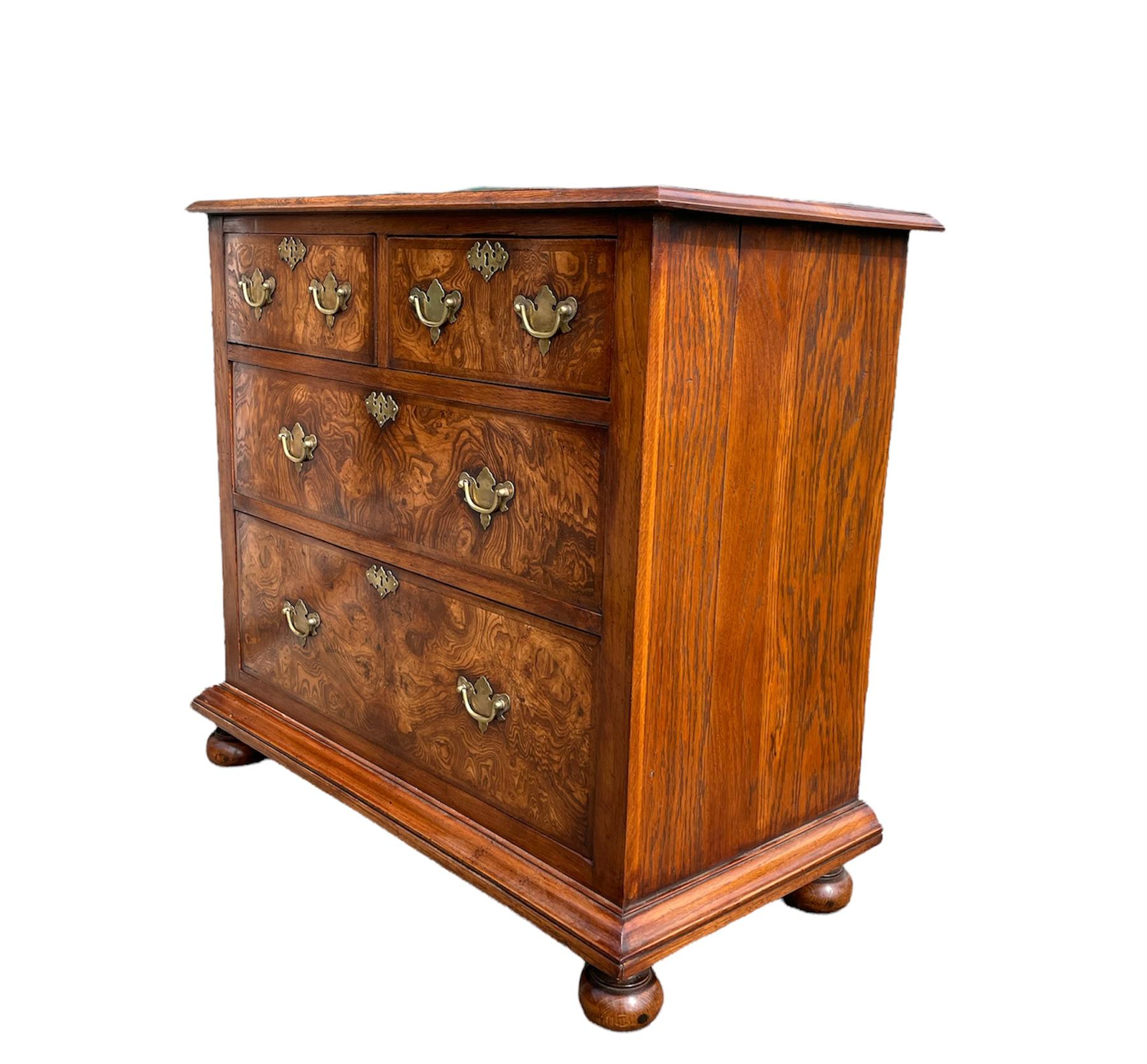 Fine quality rare burr Elm and oak chest of drawers circa 1900 .
The chest has a very unusual grain that really makes this unique .
It is a wonderful size with very good proportions .
The chest has very good brass engraved plate handles