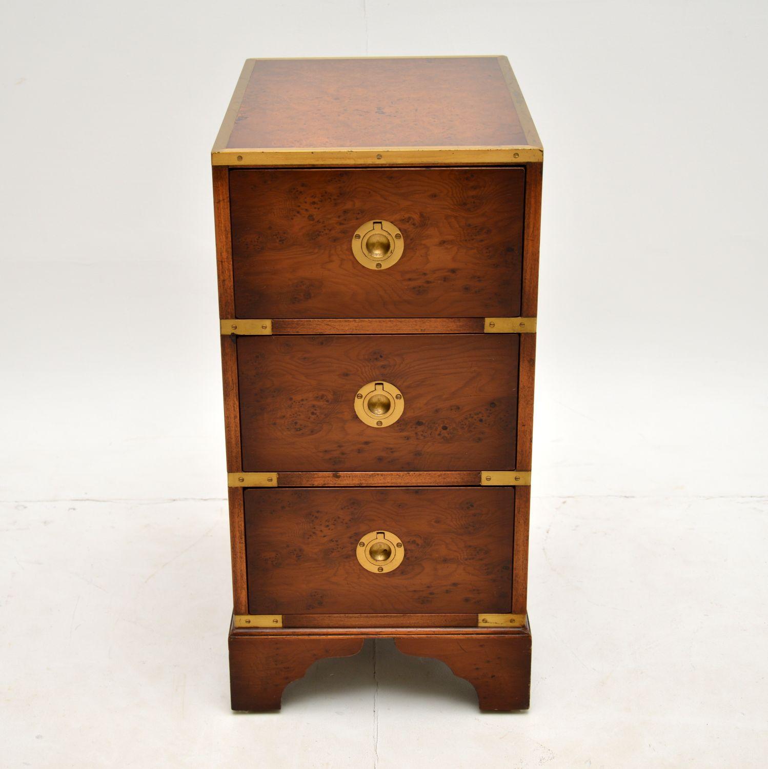 A lovely small side chest of drawers in the antique military campaign style. This was made in England, it dates from around the 1950’s.

It is a lovely size and is of great quality. There are stunning burr elm grain patterns throughout, offset by
