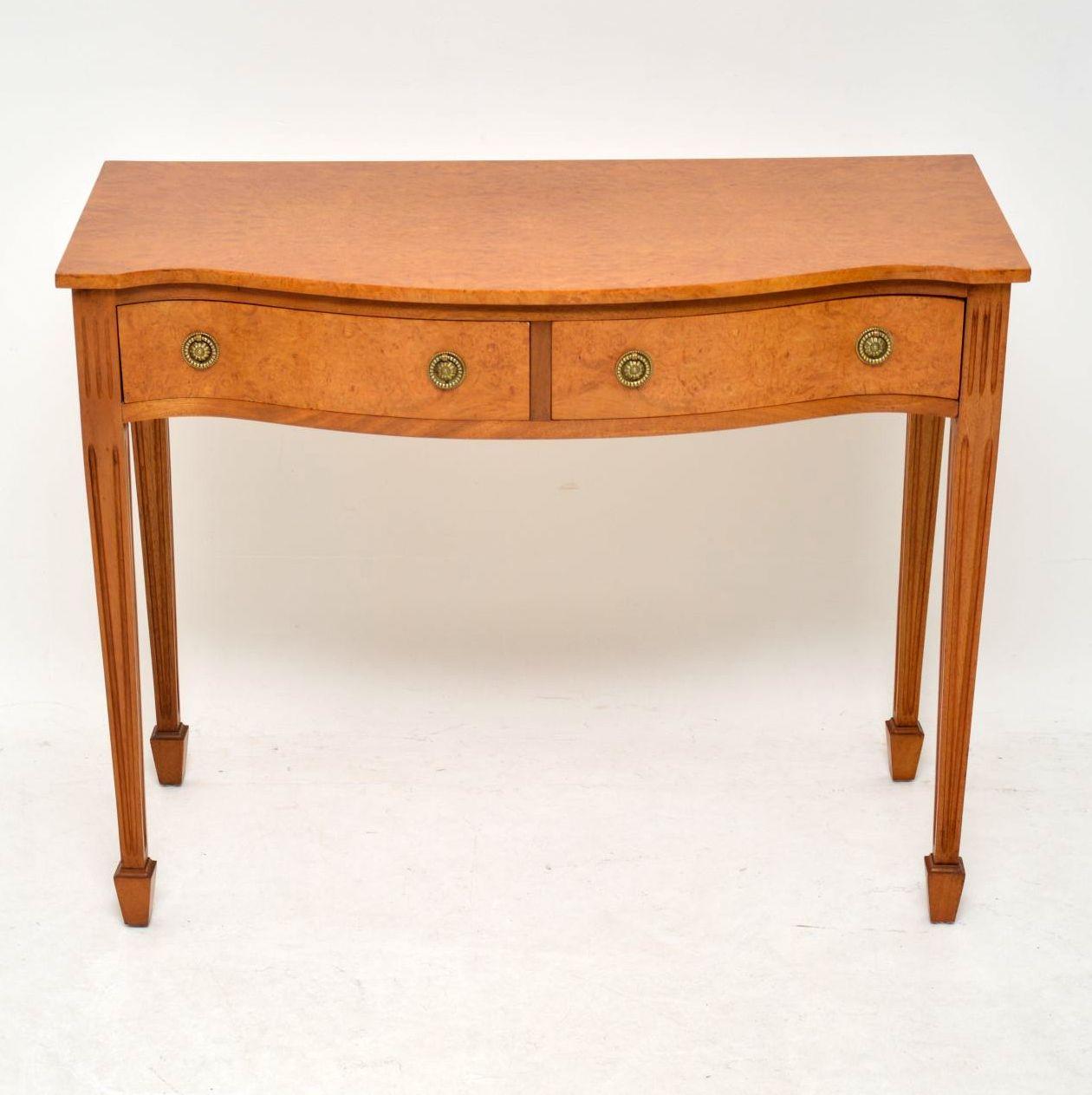Antique burr maple side table or console in good condition, having just been French polished. It’s very rare to find this sort of table in this lighter wood and this one has a wonderful color. This table has a serpentine shaped front, two drawers