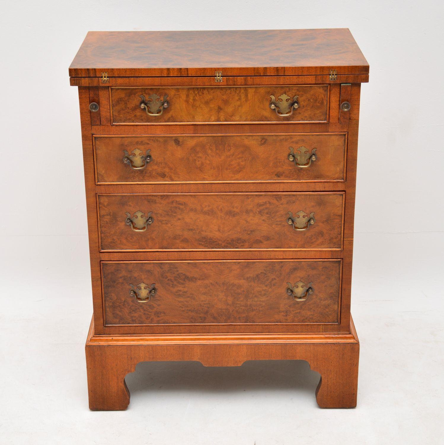 Small antique bur walnut bachelors chest of drawers with a useful fold over top that is supported on two pull out loafers. This chest is in excellent condition, having just been French polished & it dates to around the 1930s period. It has four