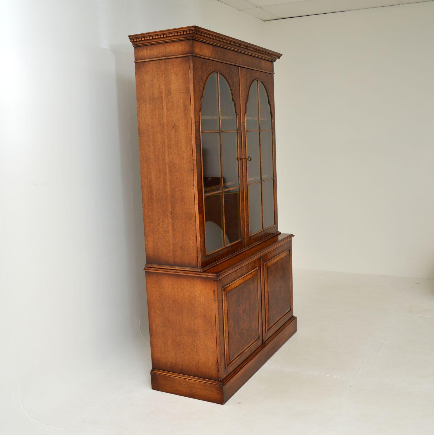 A fantastic antique bookcase in burr walnut, made in England and dating from around the 1930’s.

This is of exceptional quality, with a beautiful and impressive design. The front is finished in gorgeous burr walnut, with paneled lower doors and