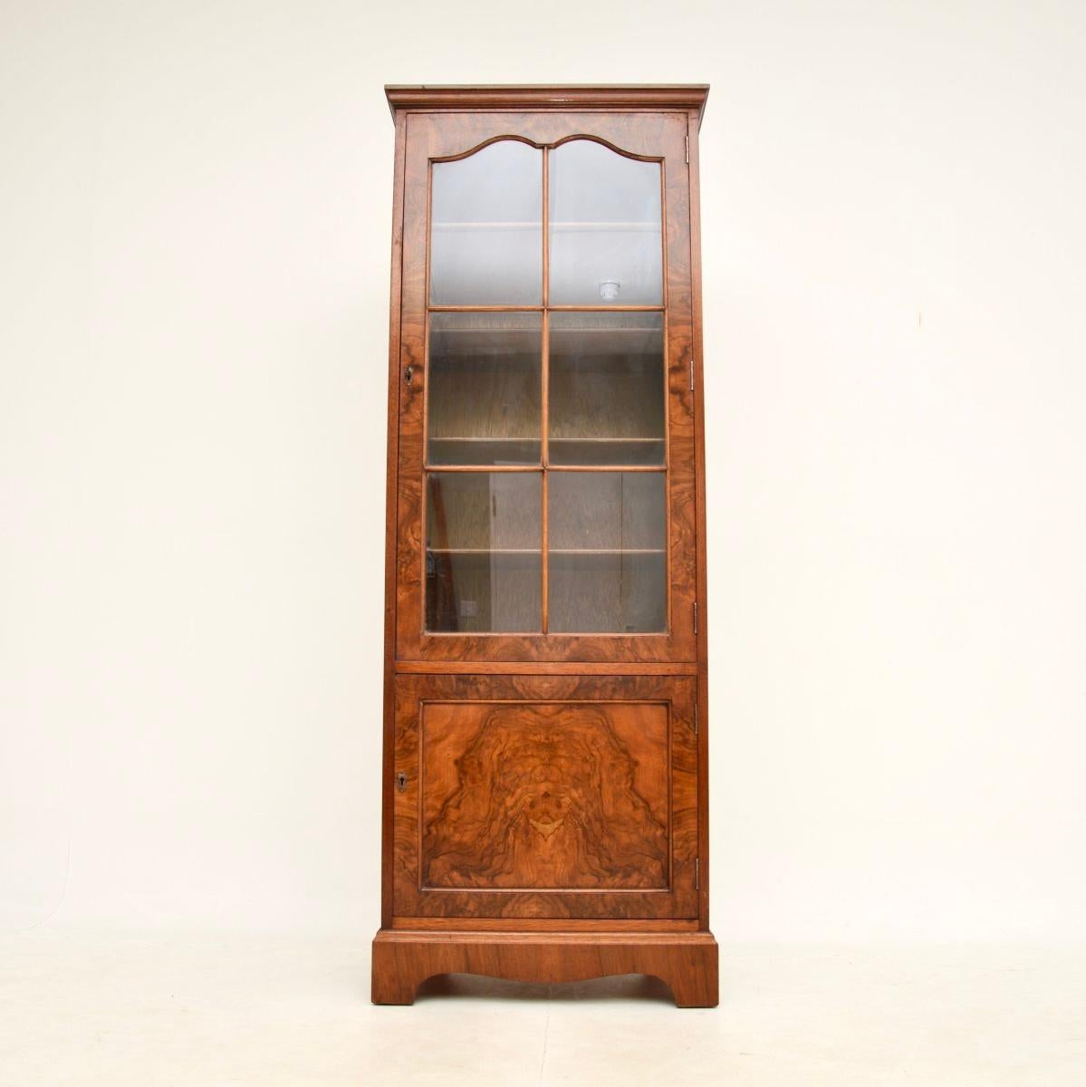 A lovely antique burr walnut bookcase in the Georgian style. This was made in England, it dates from around the 1930’s.

It is of very good quality and has lovely proportions; it is tall and slim, with lots of storage space. This has stunning burr