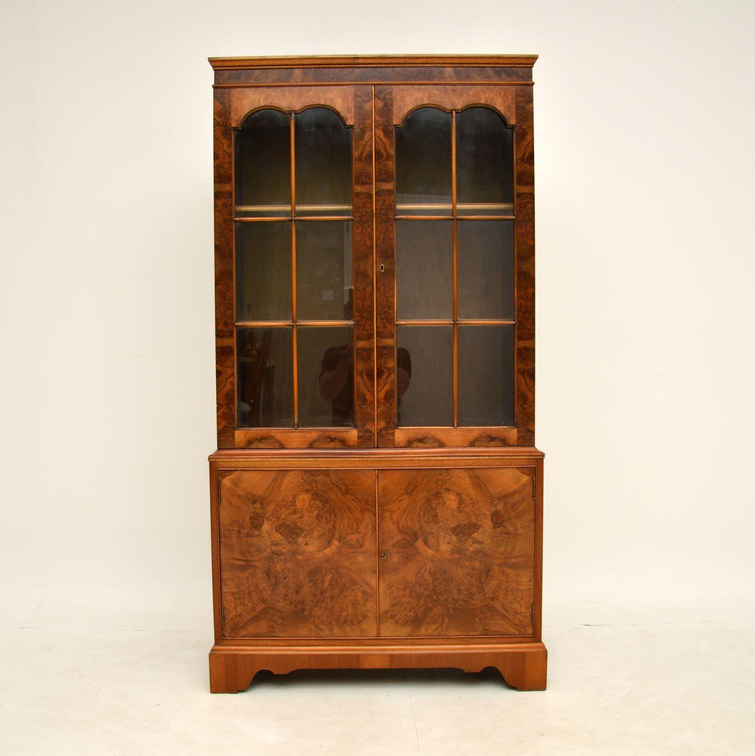 A beautiful and very useful burr walnut bookcase in the antique Georgian style, made in England & dating from around the 1930’s period.

The top section has two shelves behind astral-glazed doors & the bottom section is a little deeper, with loads