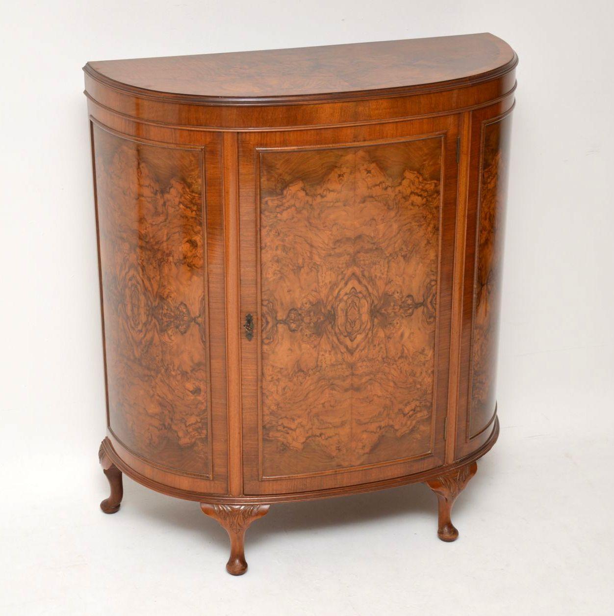 Very useful antique walnut bow fronted cabinet with plenty of storage inside & at the same time, taking up no more room than a small console side table. It has a burr walnut top & three burr walnut panels on the front, one of which is on the door.