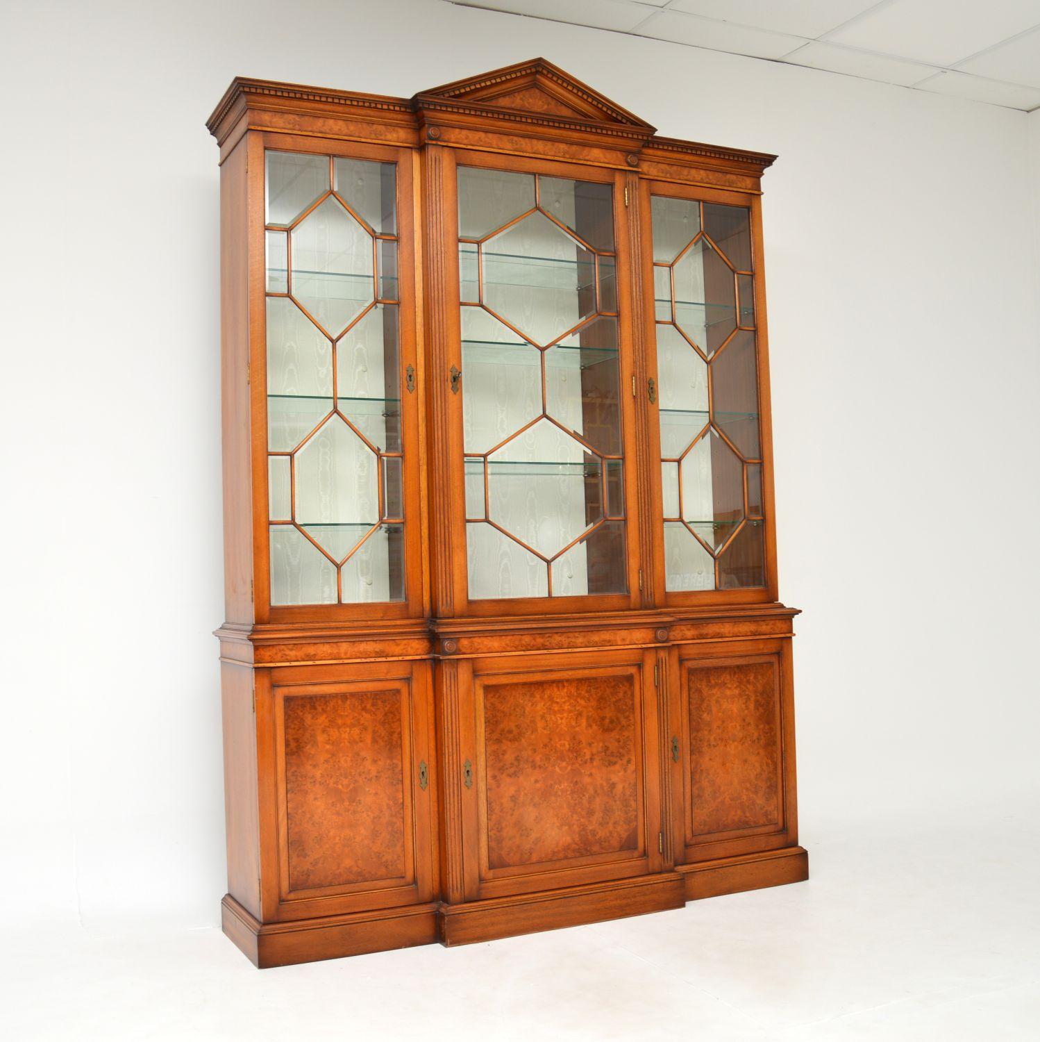 A beautiful and extremely well made breakfront bookcase in burr walnut. This was made in England & I would date it from around the 1950-60’s period.

The quality is amazing, this a large and very useful item. The top section has toughened glass