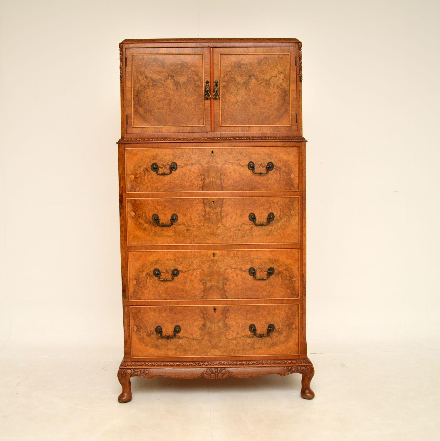 A large and very beautiful antique walnut tallboy cabinet on chest. This was made in England & dates from around the 1920-1930’s period.

It is of superb quality, with gorgeous burr walnut veneers on the front, and crisp carving around the edges