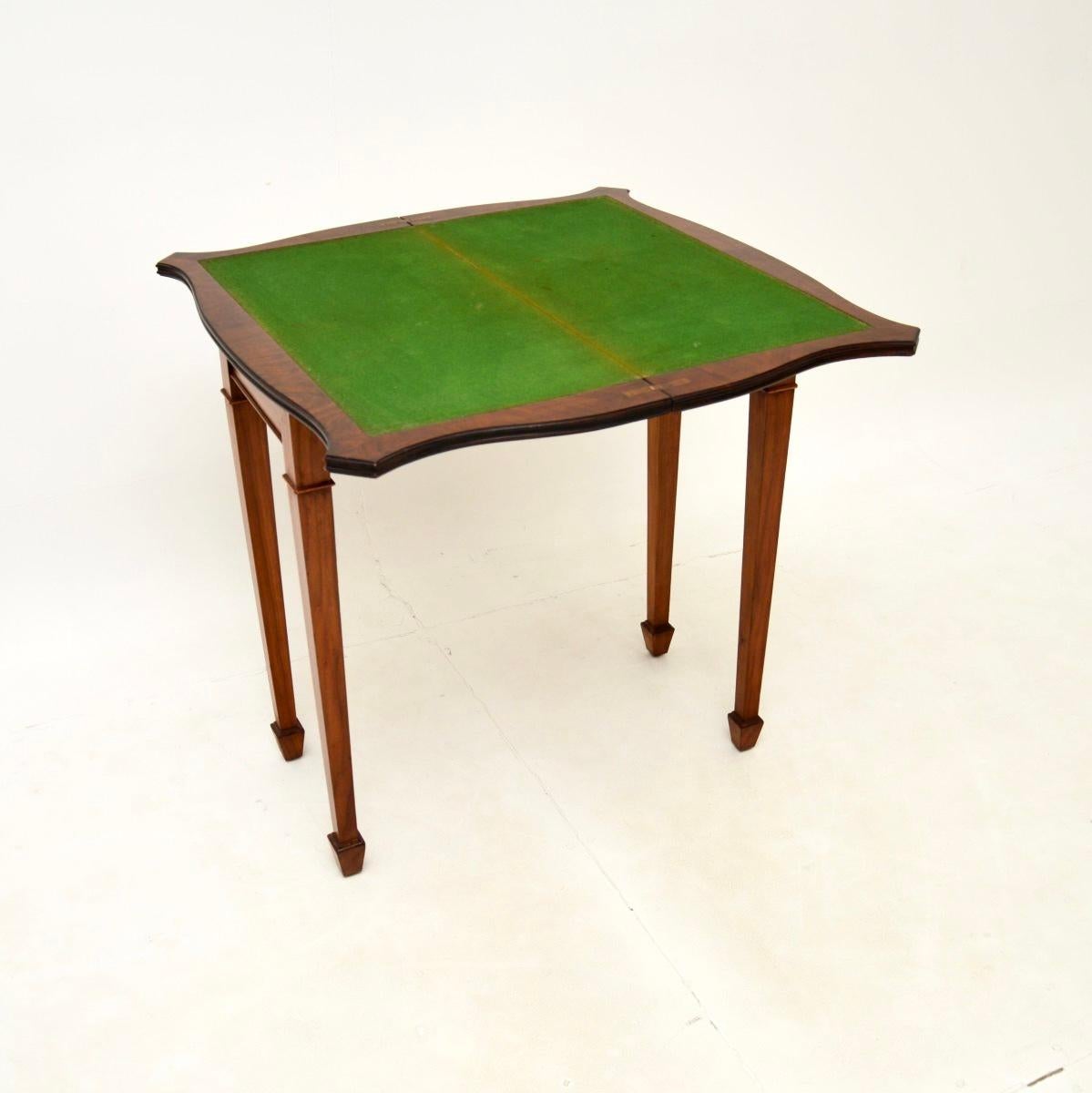 A lovely antique burr walnut card / console table in the Georgian style. This was made in England, it dates from around the 1950’s.

It is of superb quality and is a very useful size to be used as a console table. The top swivels round and flips