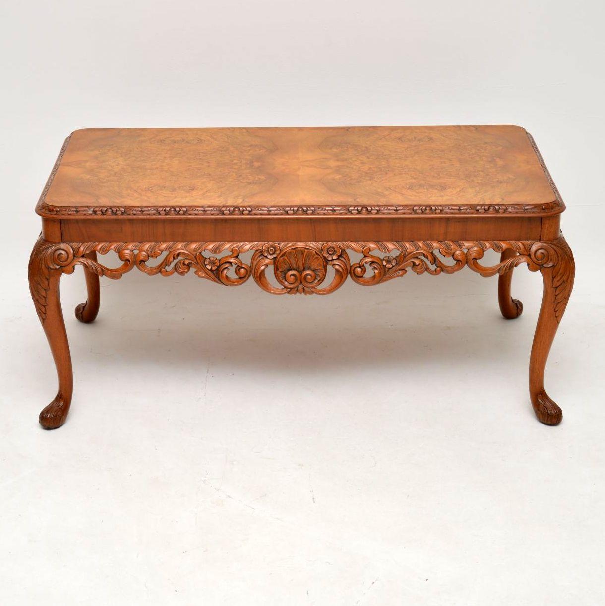 This antique walnut coffee table is in excellent condition & has a lovely warm mellow colour. The top is burr walnut with a carved edge. The solid walnut legs are carved & between the legs the pieced carving is absolutely stunning. I would date this