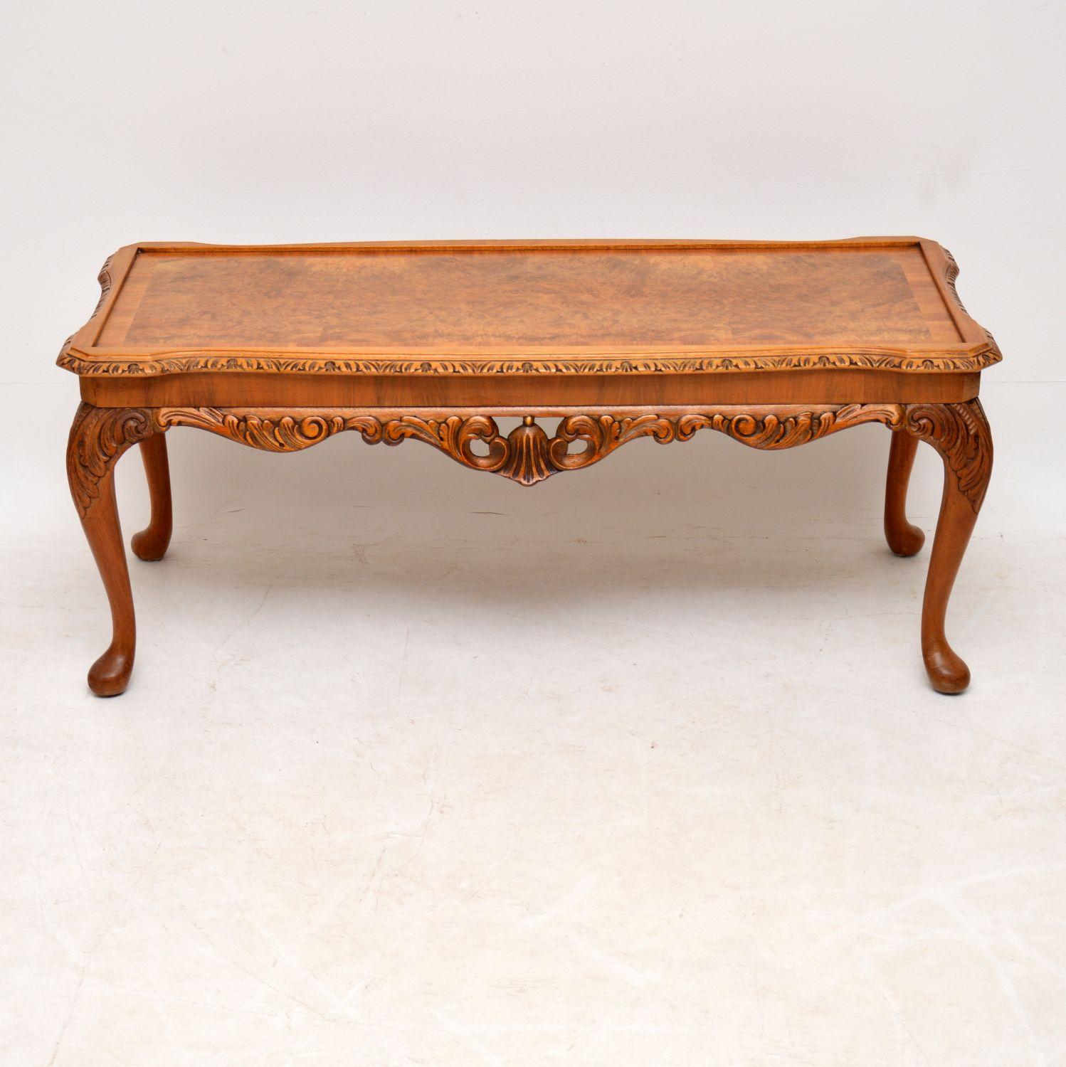 Antique Queen Anne style walnut coffee table in excellent condition and dating to circa 1930s period. It has a crossbanded burr walnut top, with shaped carved edges, plus fine carvings between and on the solid walnut legs. This coffee table has just